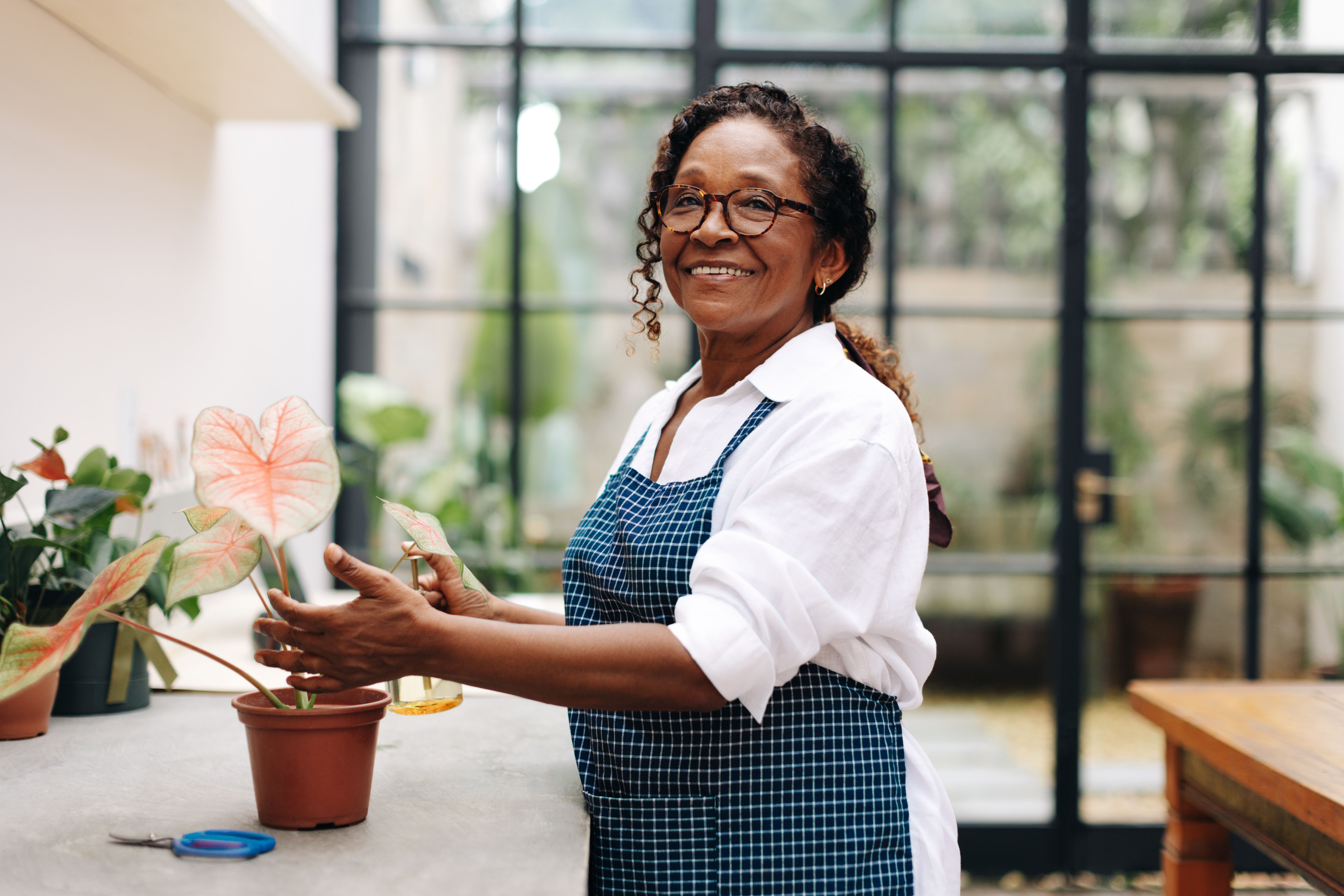 Black business woman growing flowers for her floral startup