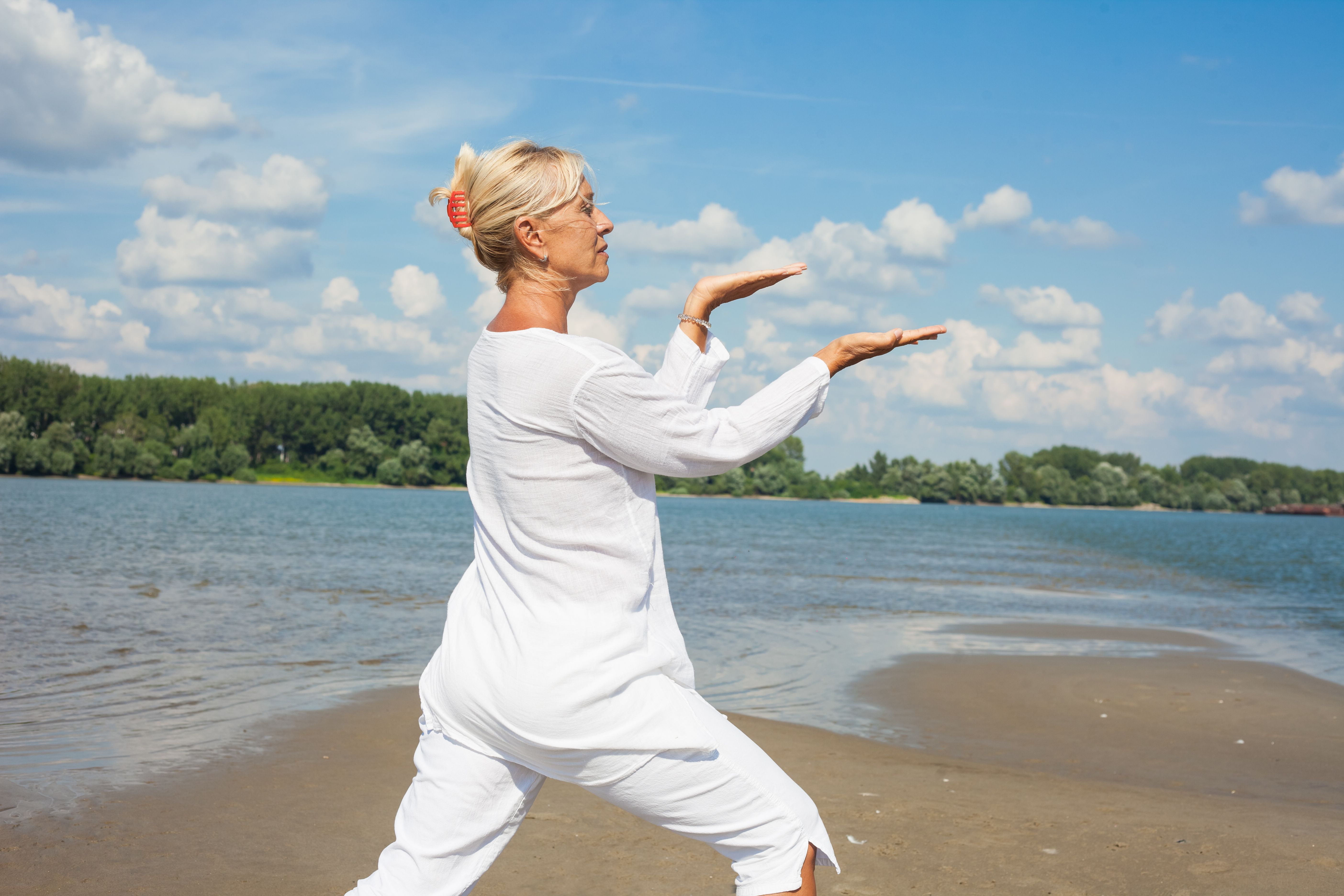 Woman in white clothes doing tai chi