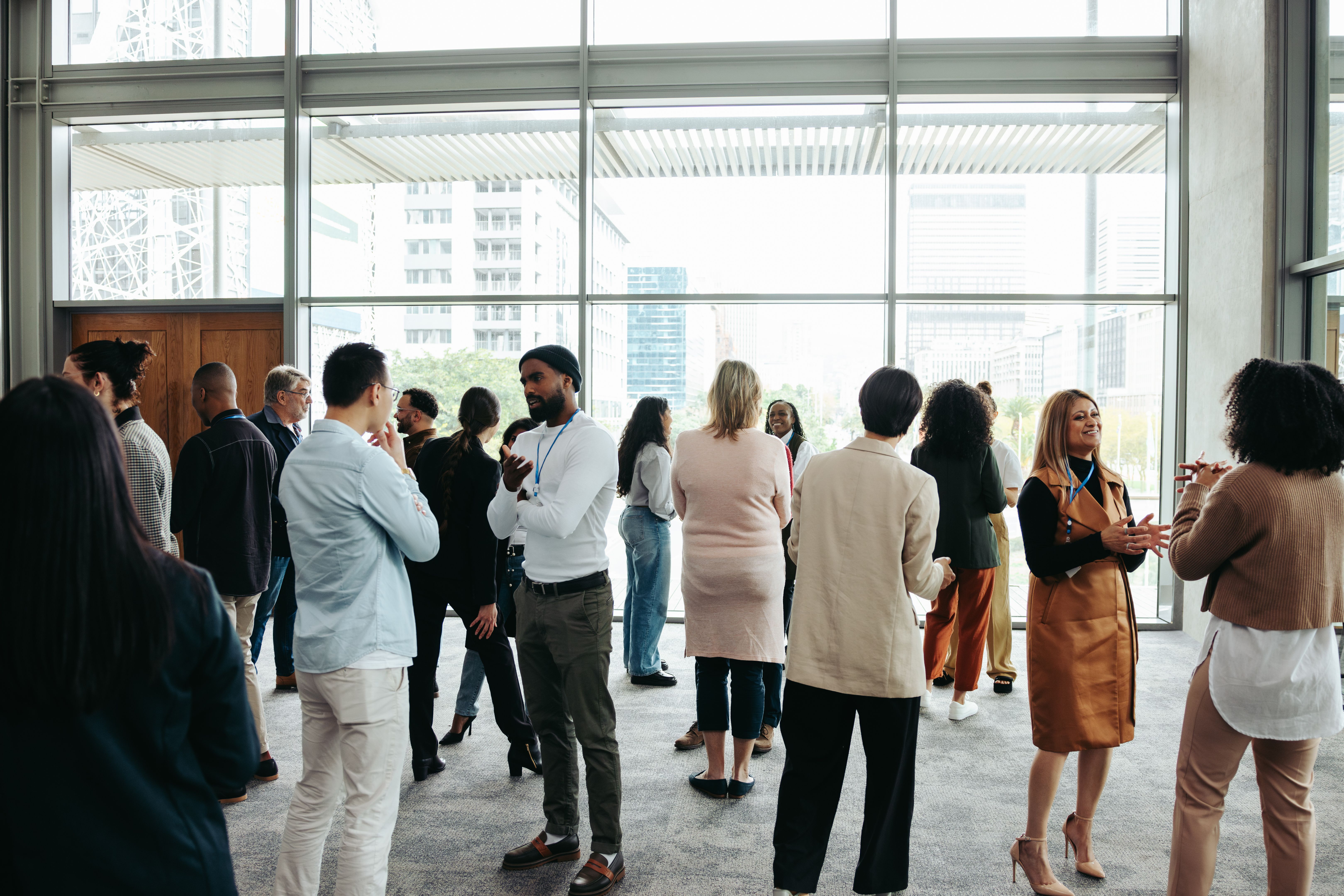 Corporate crowd engaging in teamwork during business event in modern office space