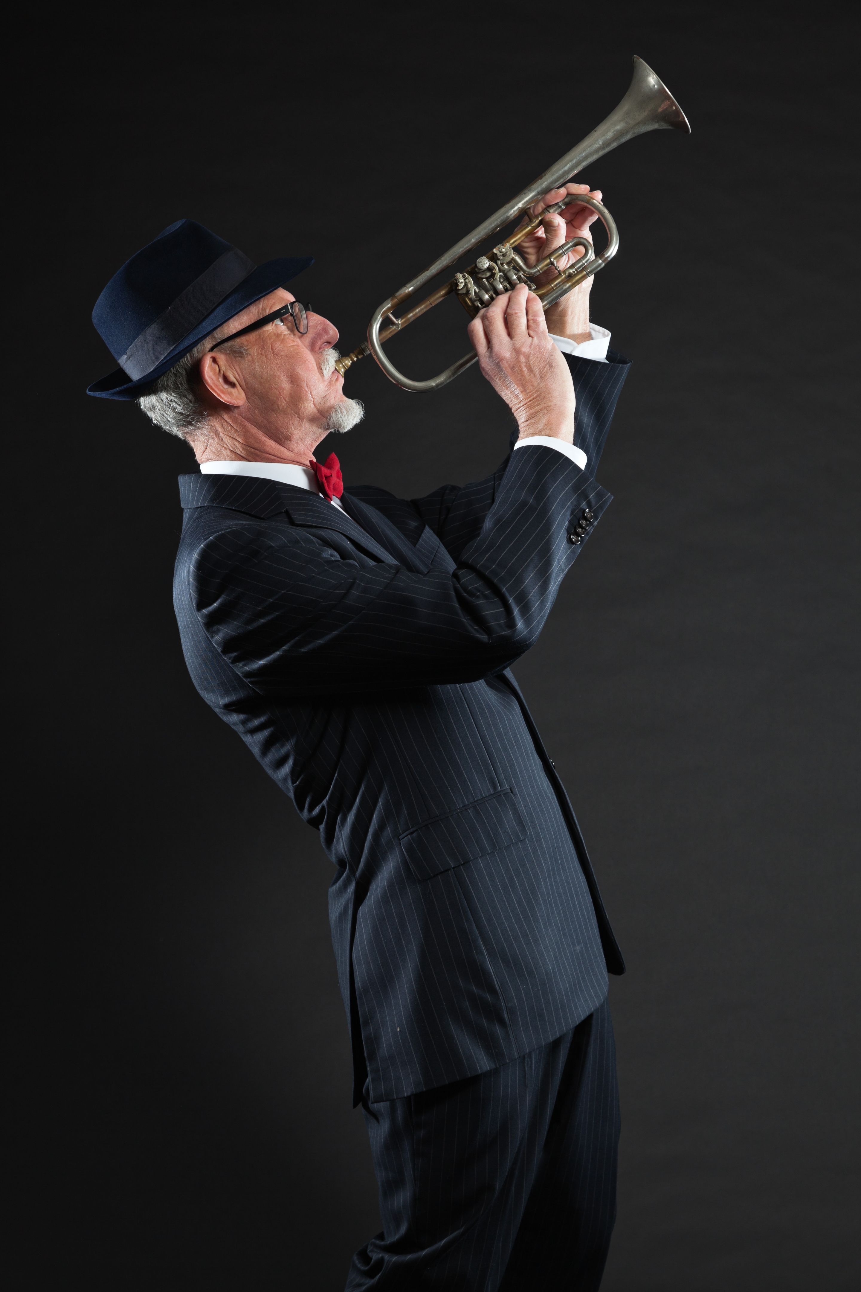Senior jazz musician. Trumpet player. Studio shot.