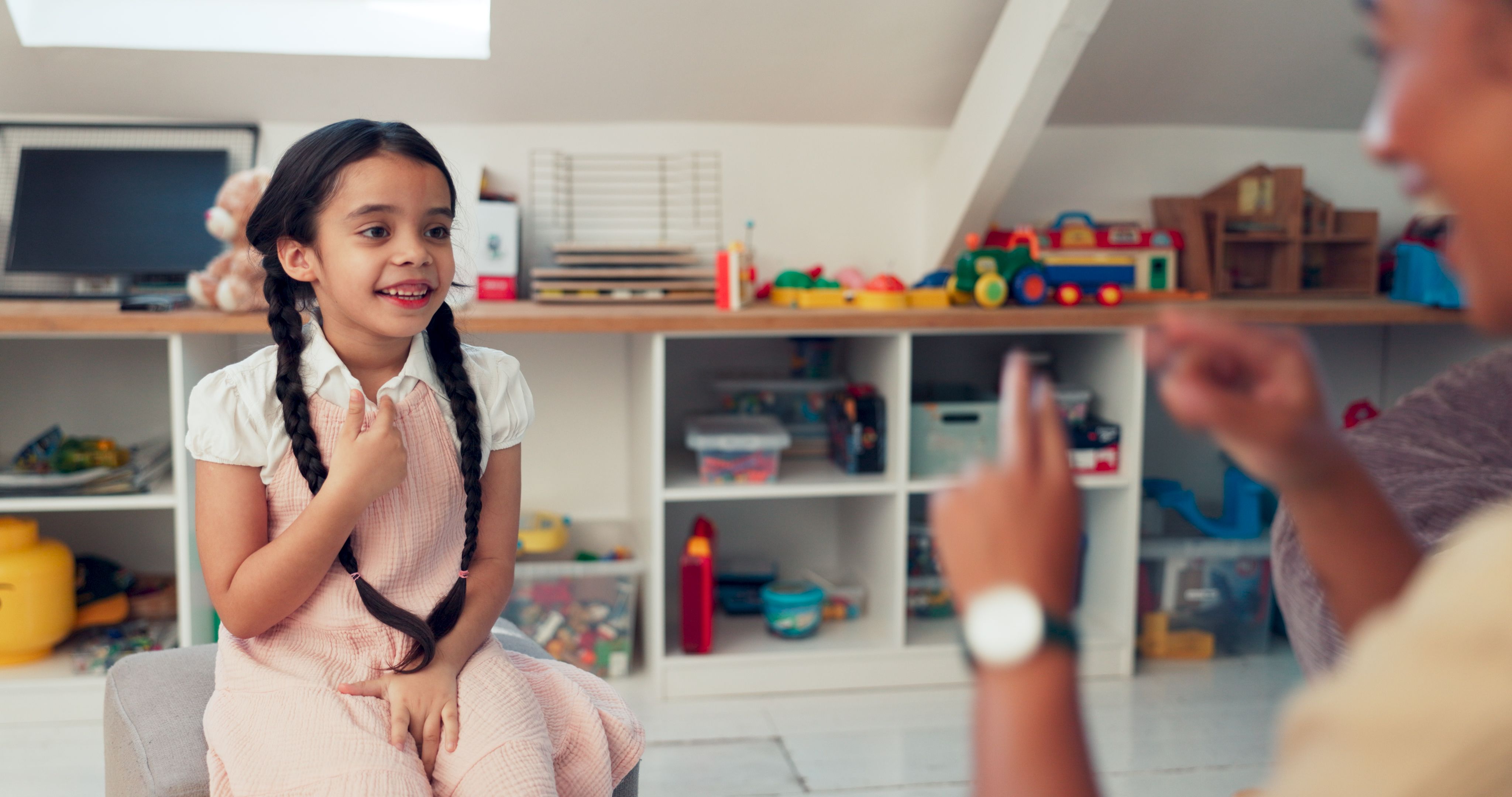 Girl, kid and sign for speech therapy, communication and verbal practice for phonological disorder. Woman, child and happy for technique or skill for vocal development, activity and exercise.