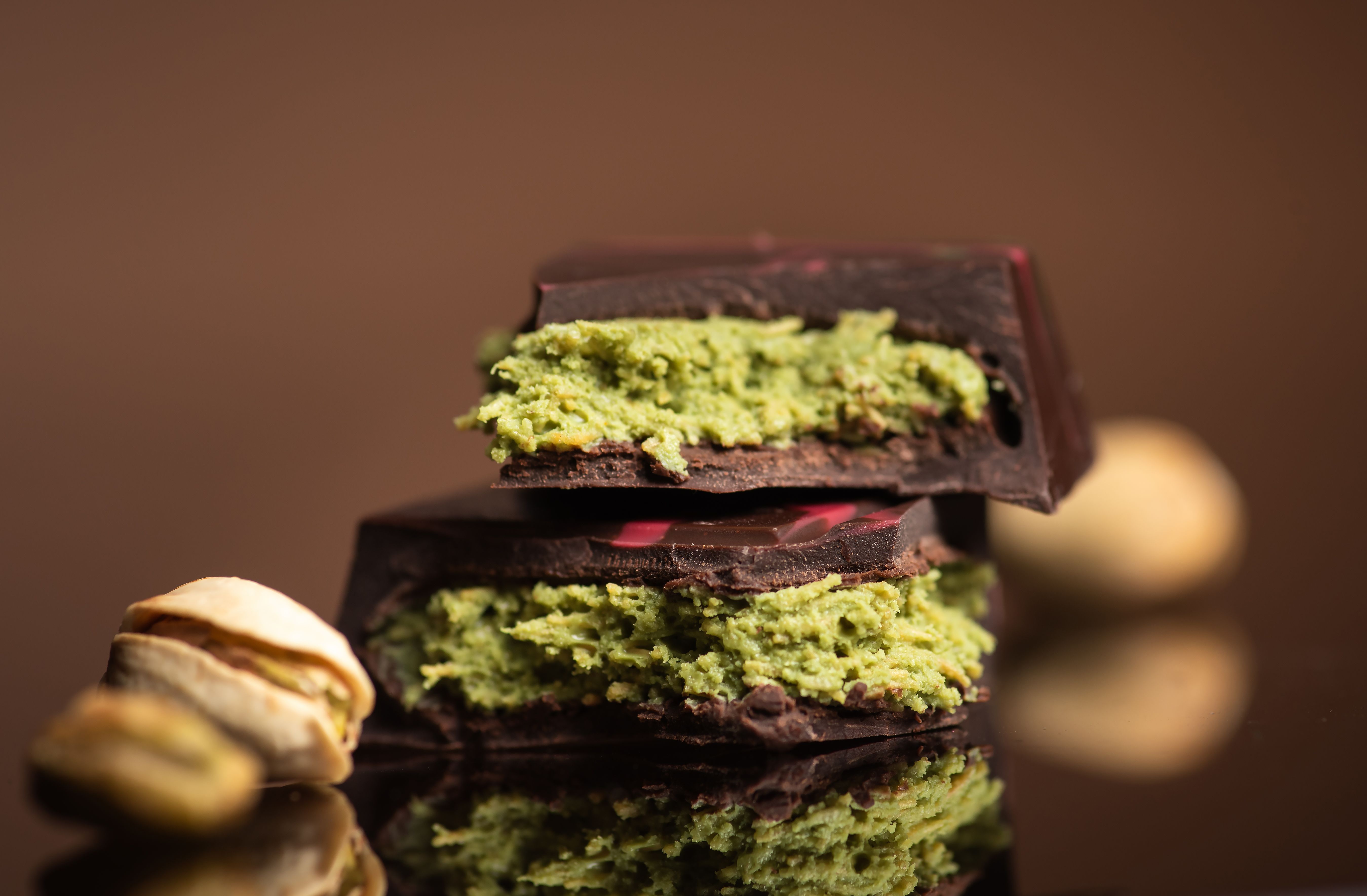 Artful Slice of Chocolate with Green Pistachio Kunafa Filling in the Center Artful Slice of Chocolate with Green Pistachio Kunafa Filling in the Center