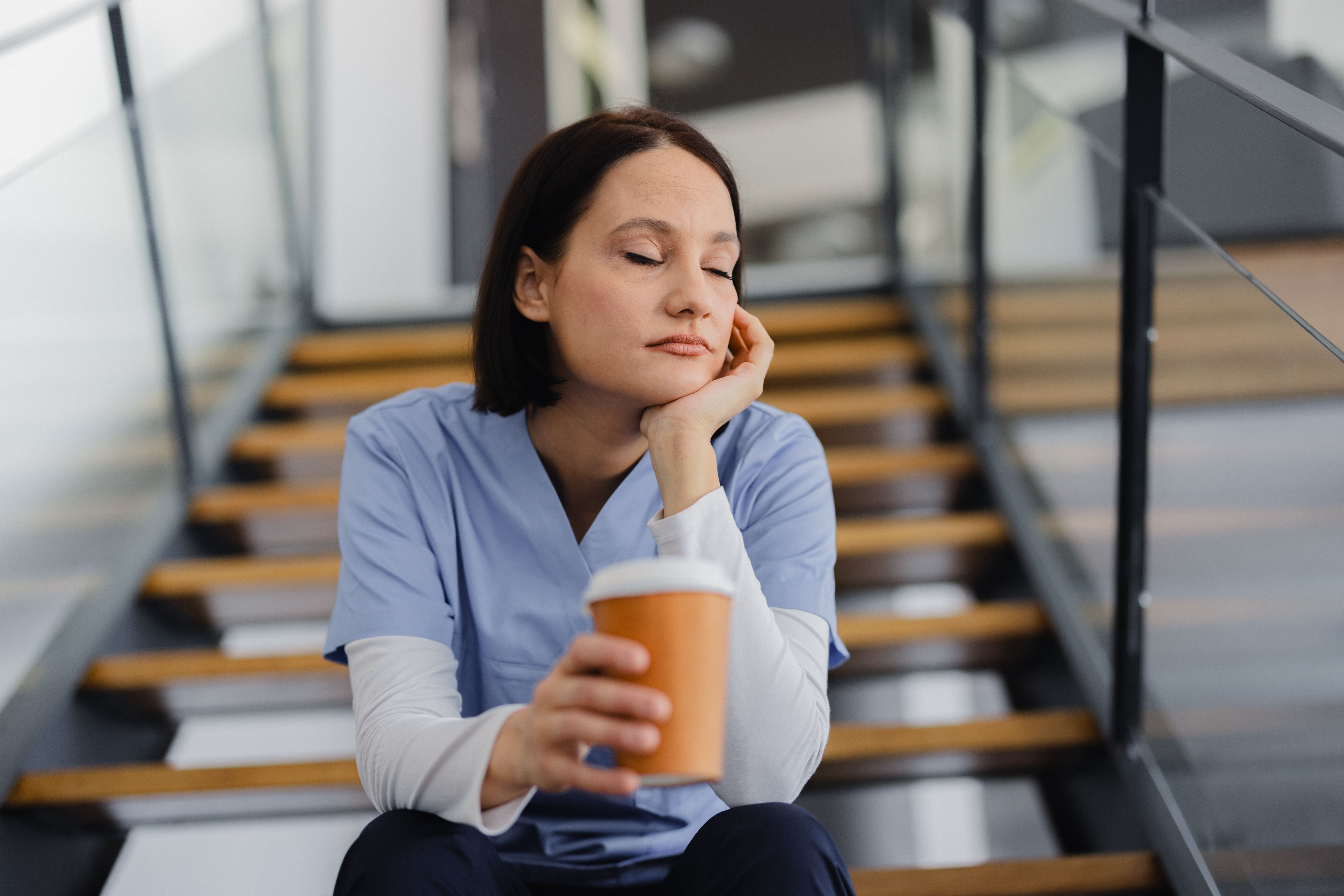 Tired female nurse, resting during an coffee break at the hospital