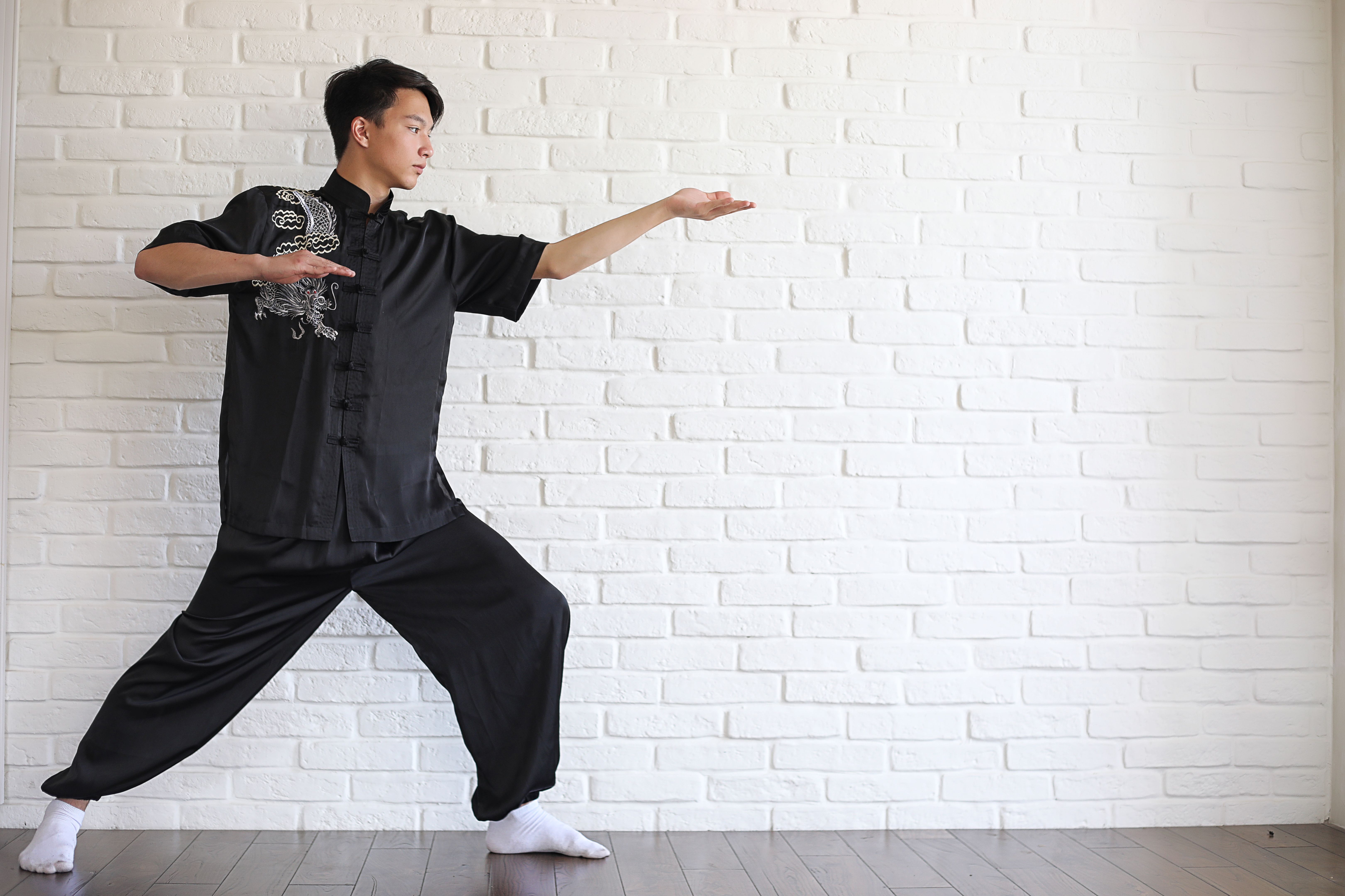 Asian young novice on a white brick wall