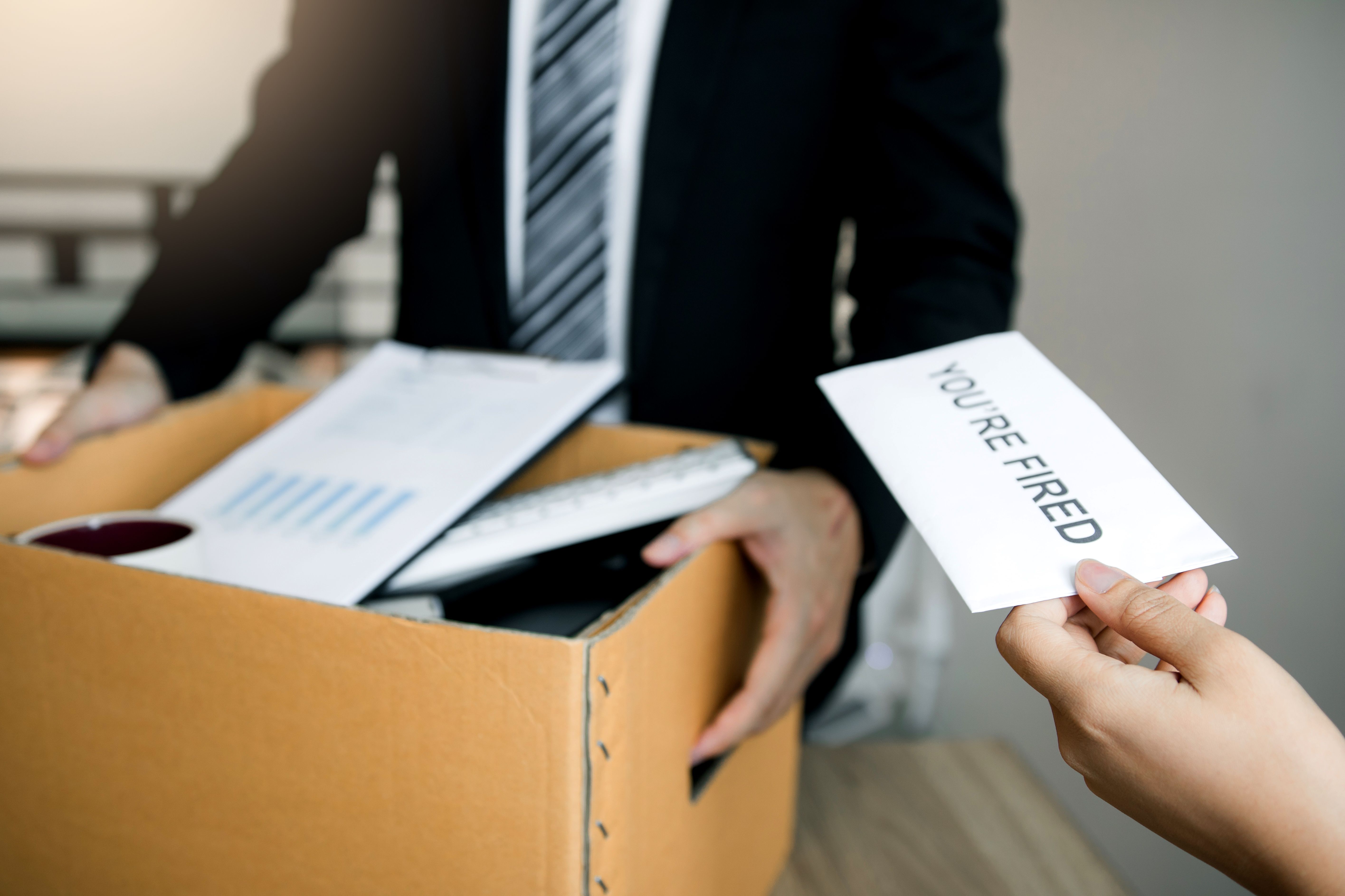 Female manager submits a resignation letter or envelope to the male employee at the office. Female manager submits a resignation letter or envelope to the male employee at the office.