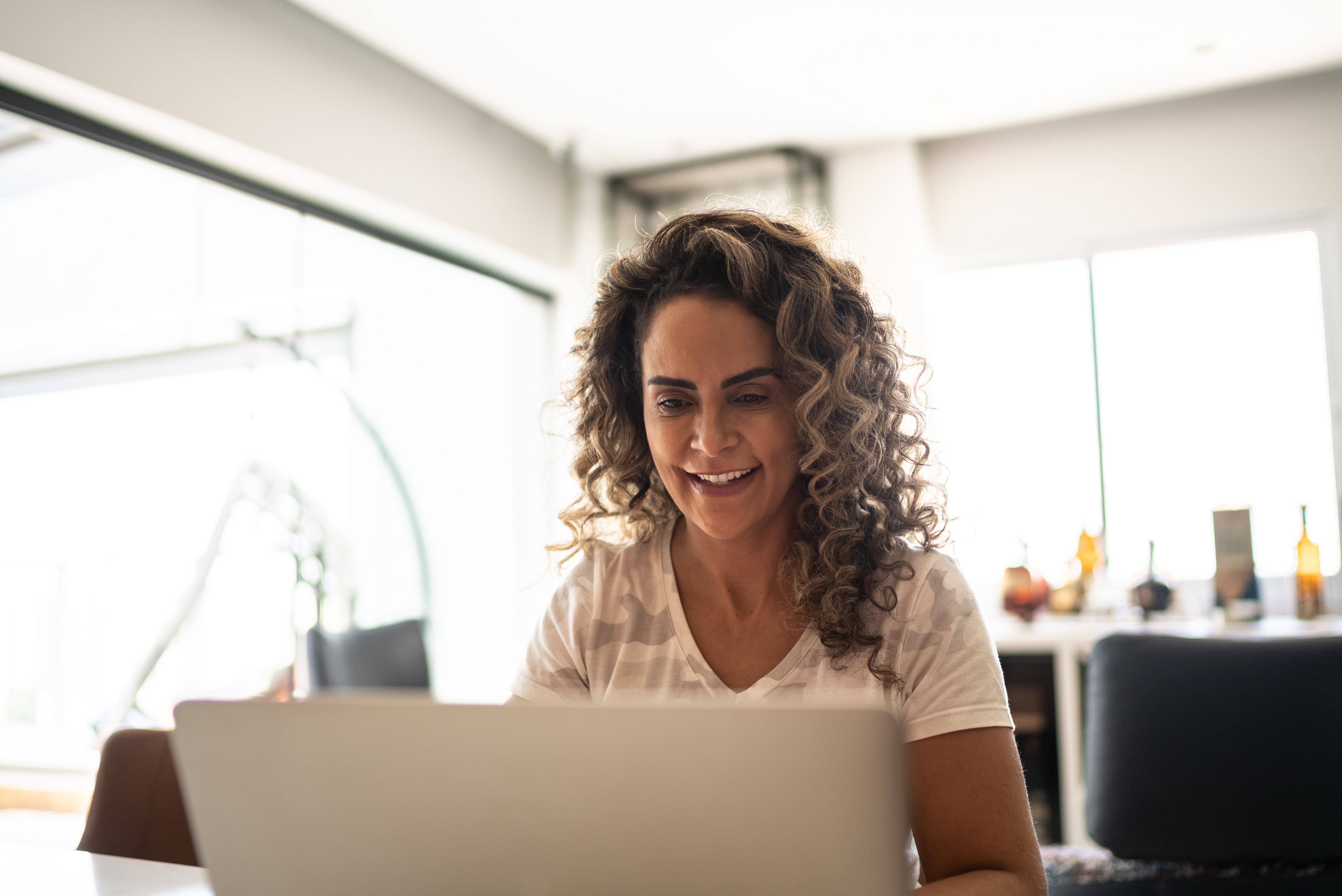 Mature woman using laptop at home