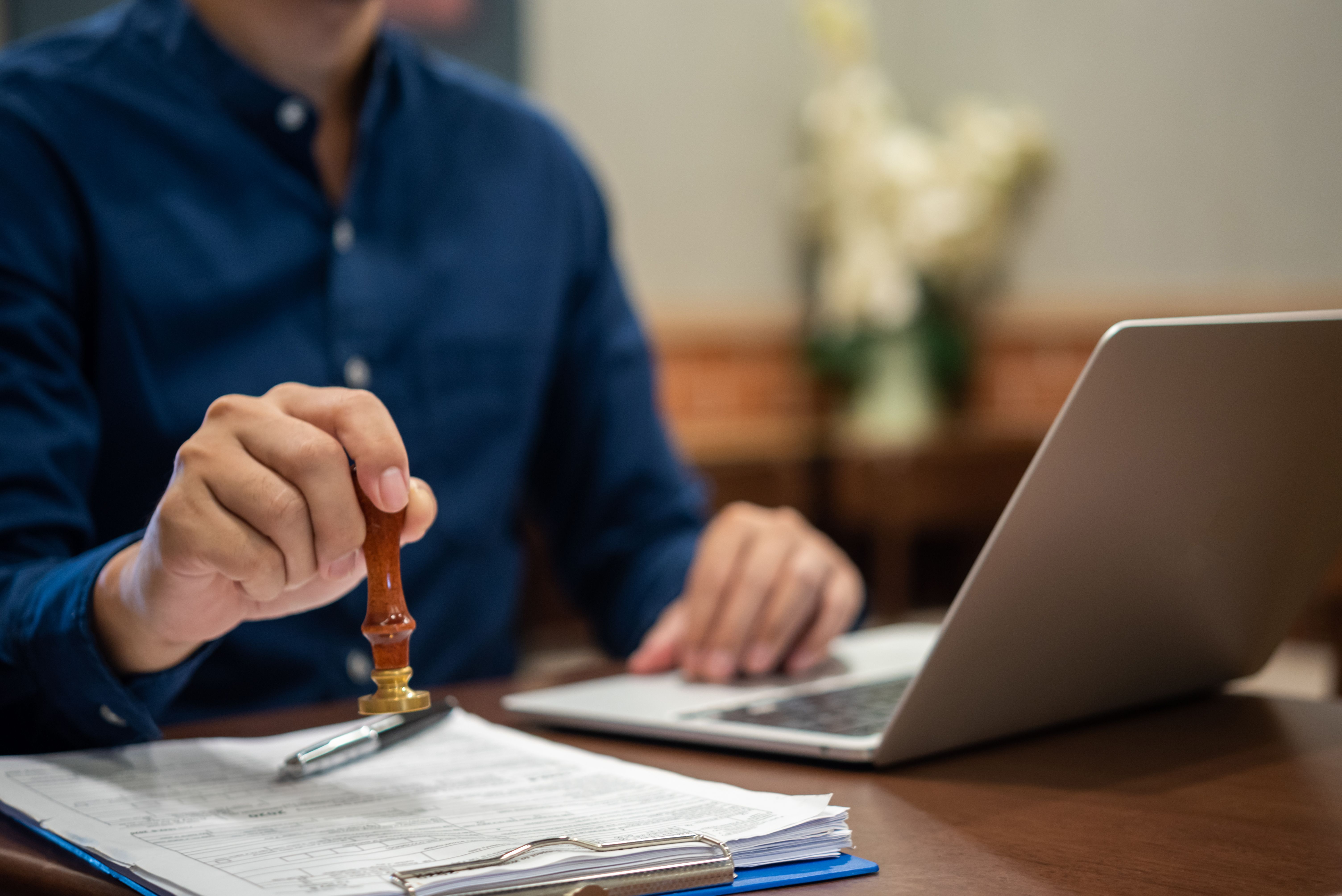 Hand stamping approved on certificate Document in notary law or business finance significance of the transaction agreements.