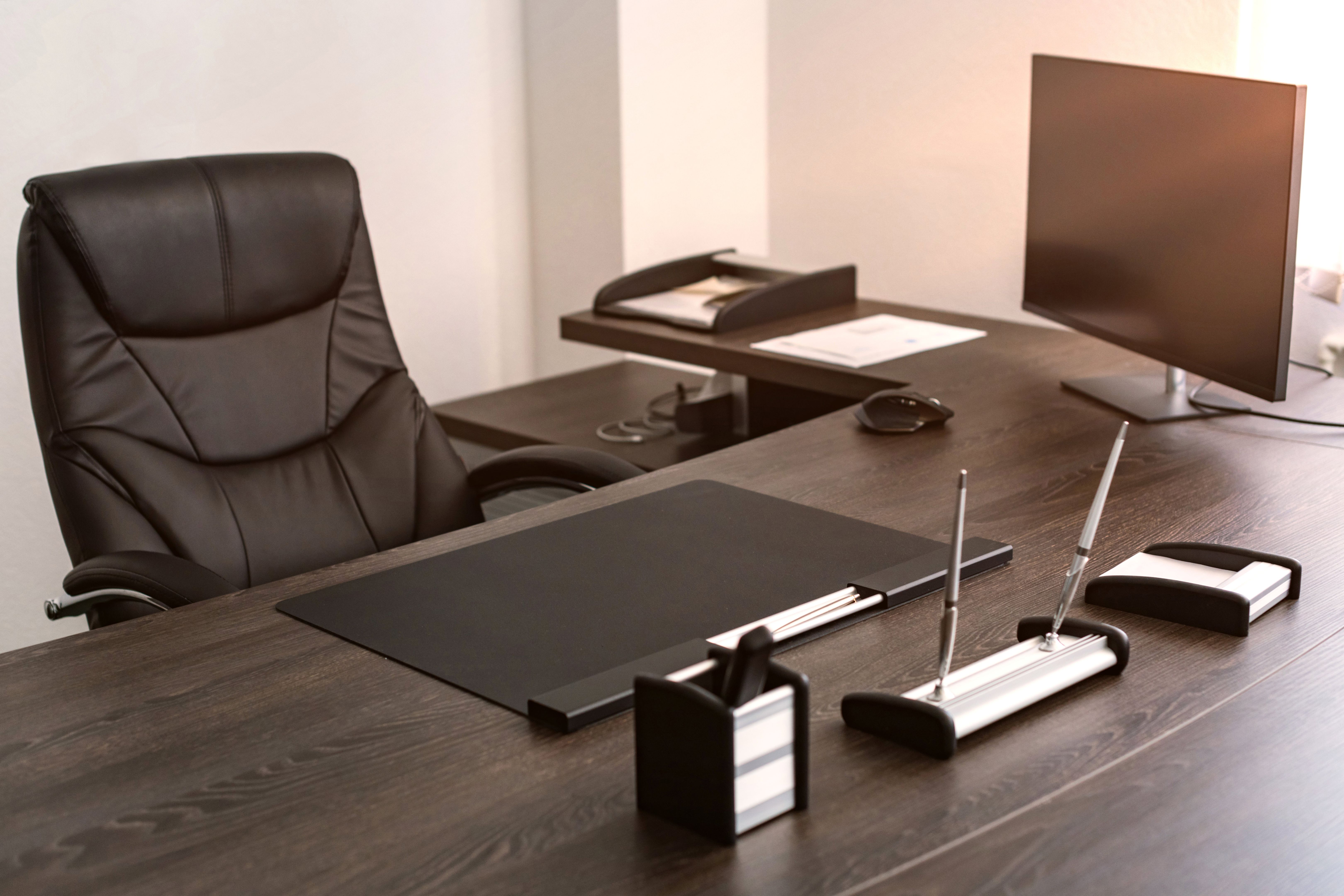 Workplace of chief of company: leather chair, writing instruments, monitor. Workplace of chief of company: leather chair, writing instruments, monitor.