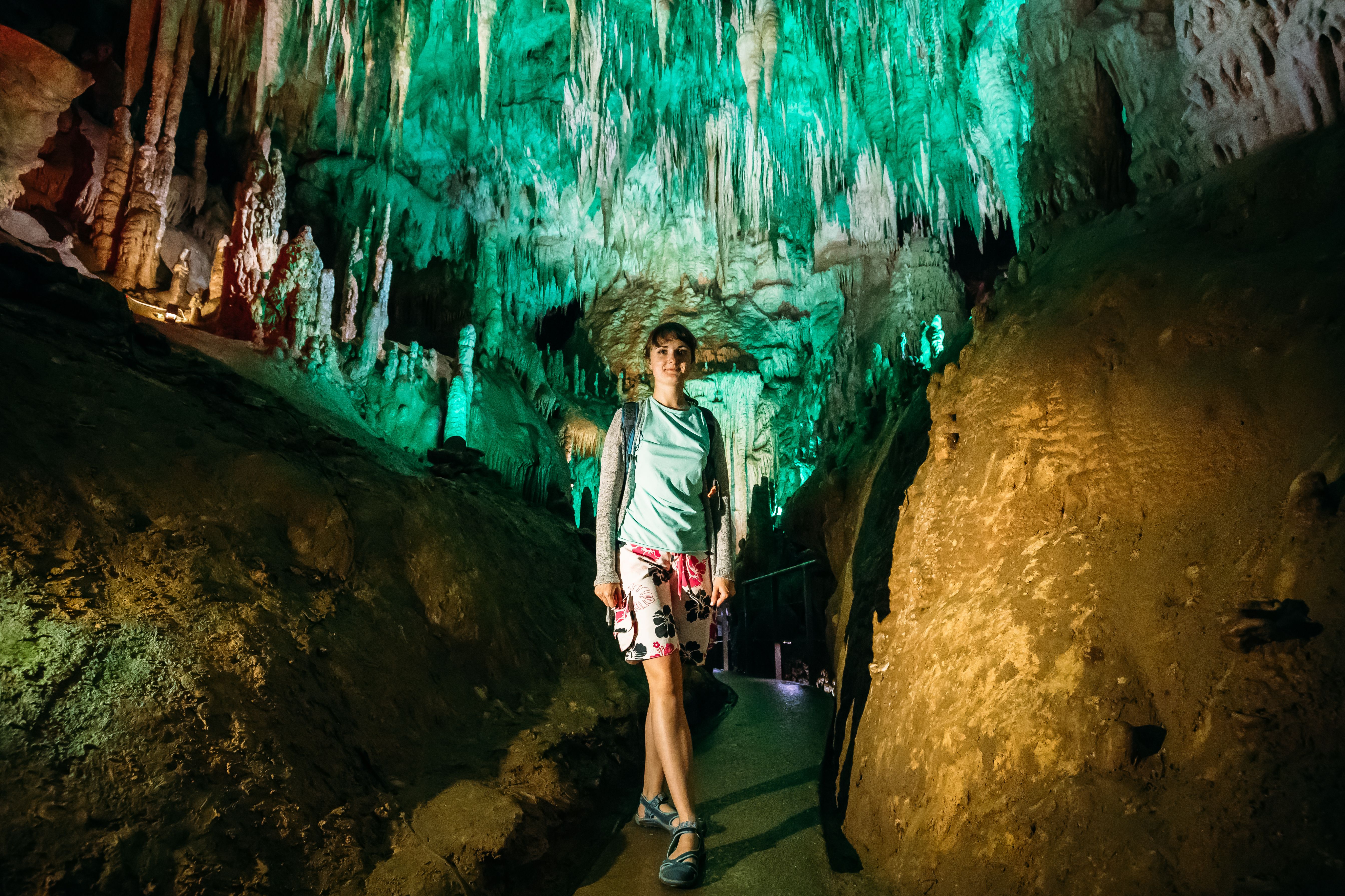 Kutaisi, Georgia. Young Woman Posing In Prometheus Cave Also Called Kumistavi Cave