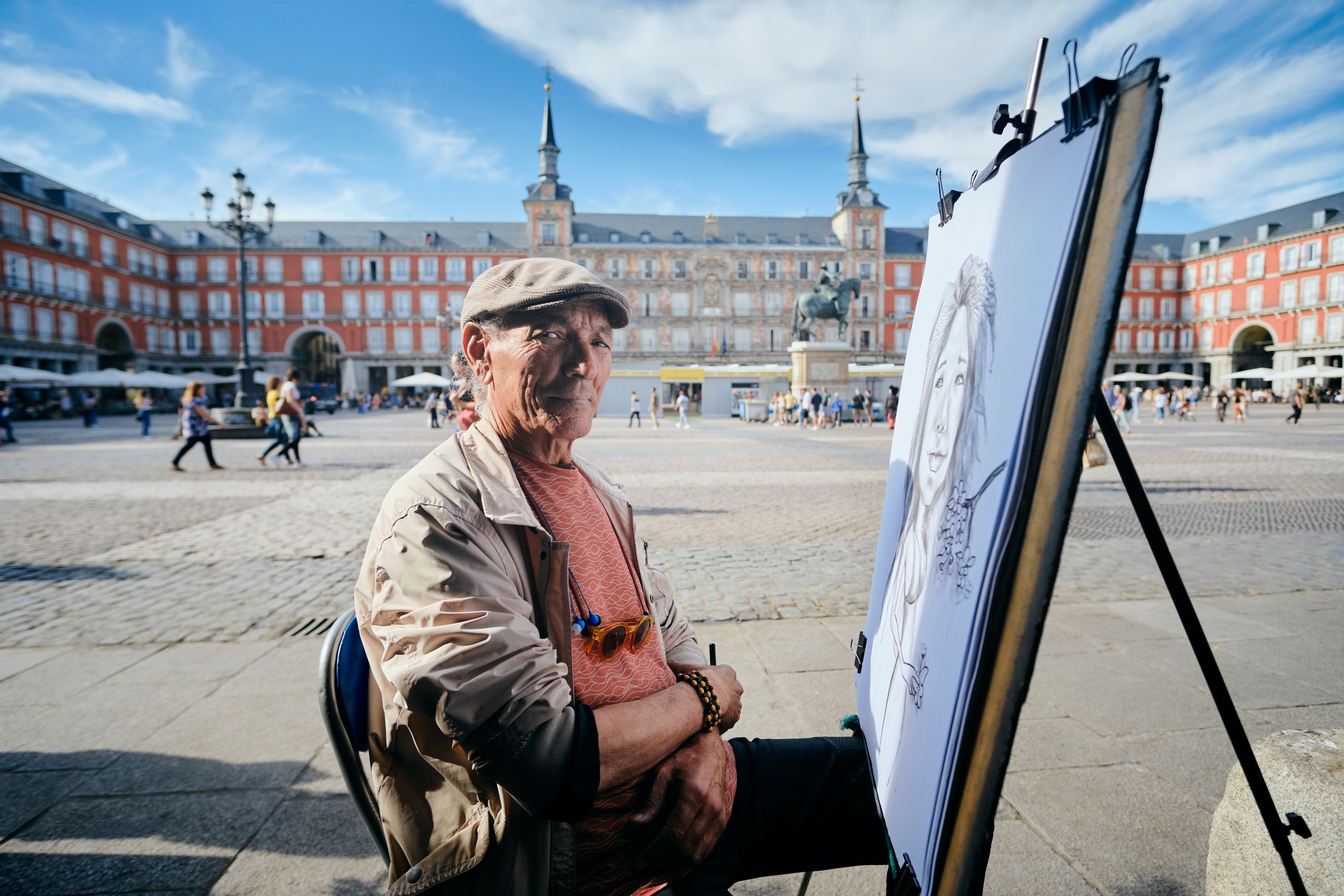 Old Male Street Painter Drawing Portrait Of Tourist Old Male Street Painter Drawing Portrait Of Tourist
