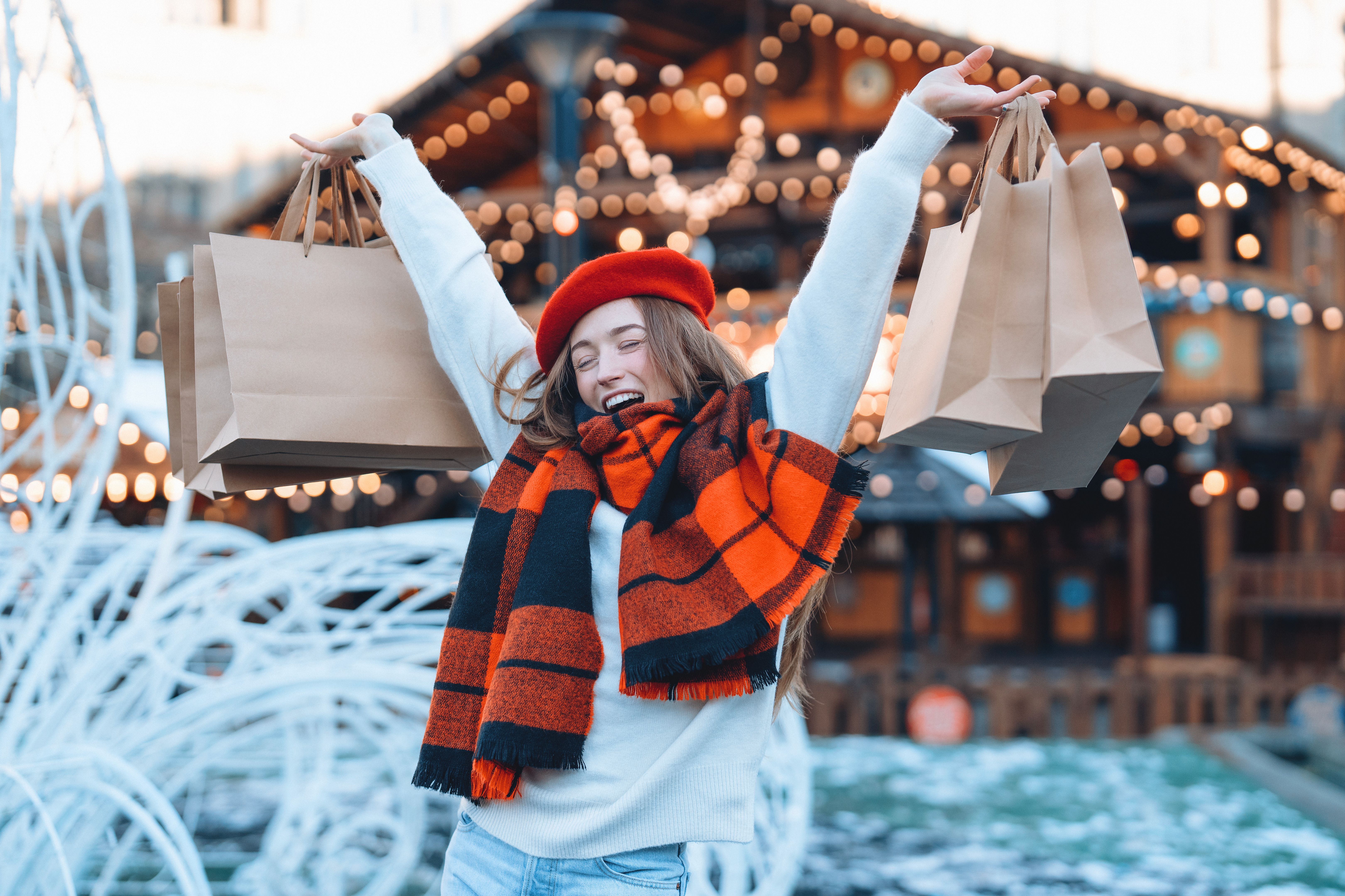 Happy women buying clothes in second hand vintage market in city street - Shopping and retail life style concept