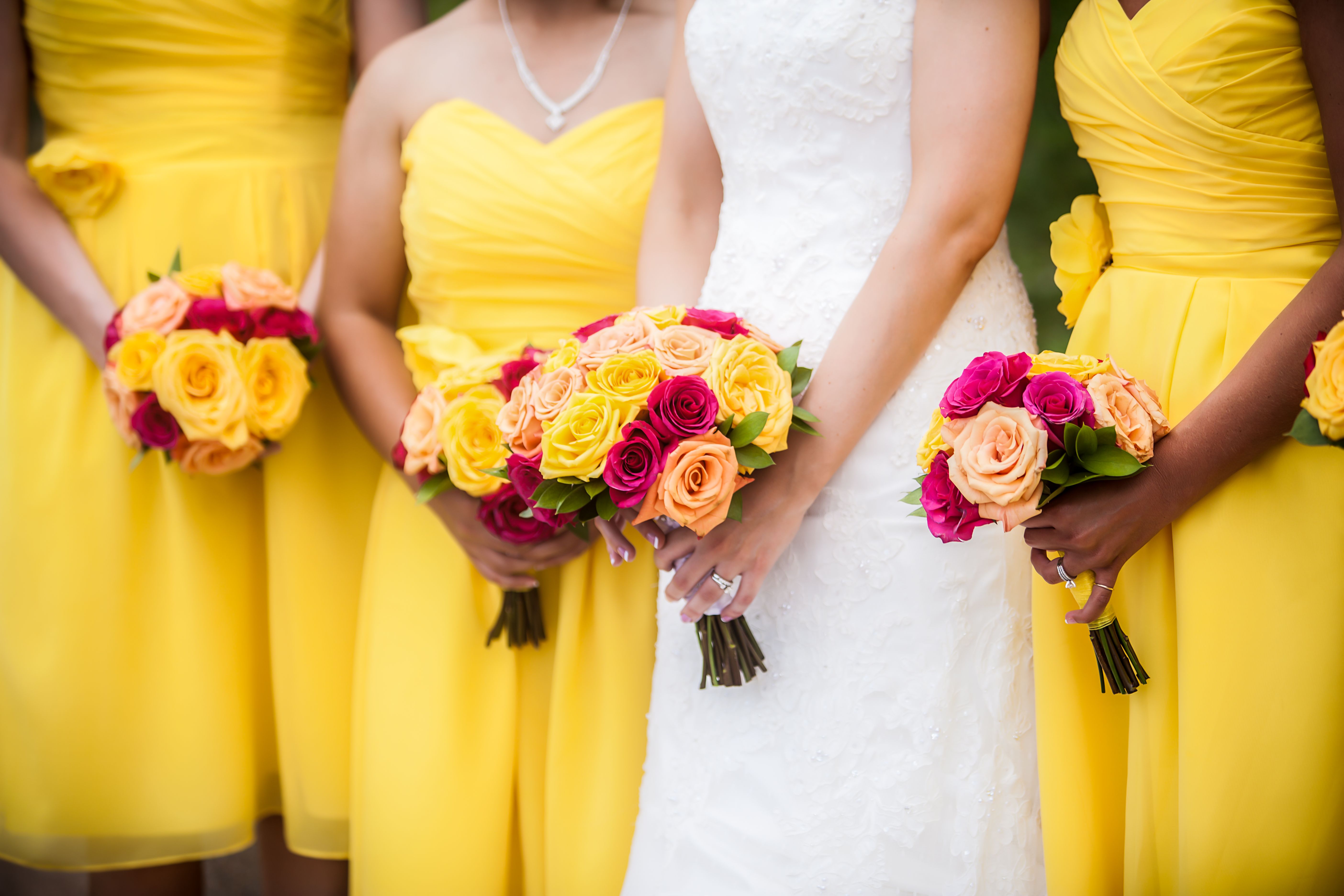 Bride Holding Bouquet with Bridesmaids in Background Bride Holding Bouquet with Bridesmaids in Background