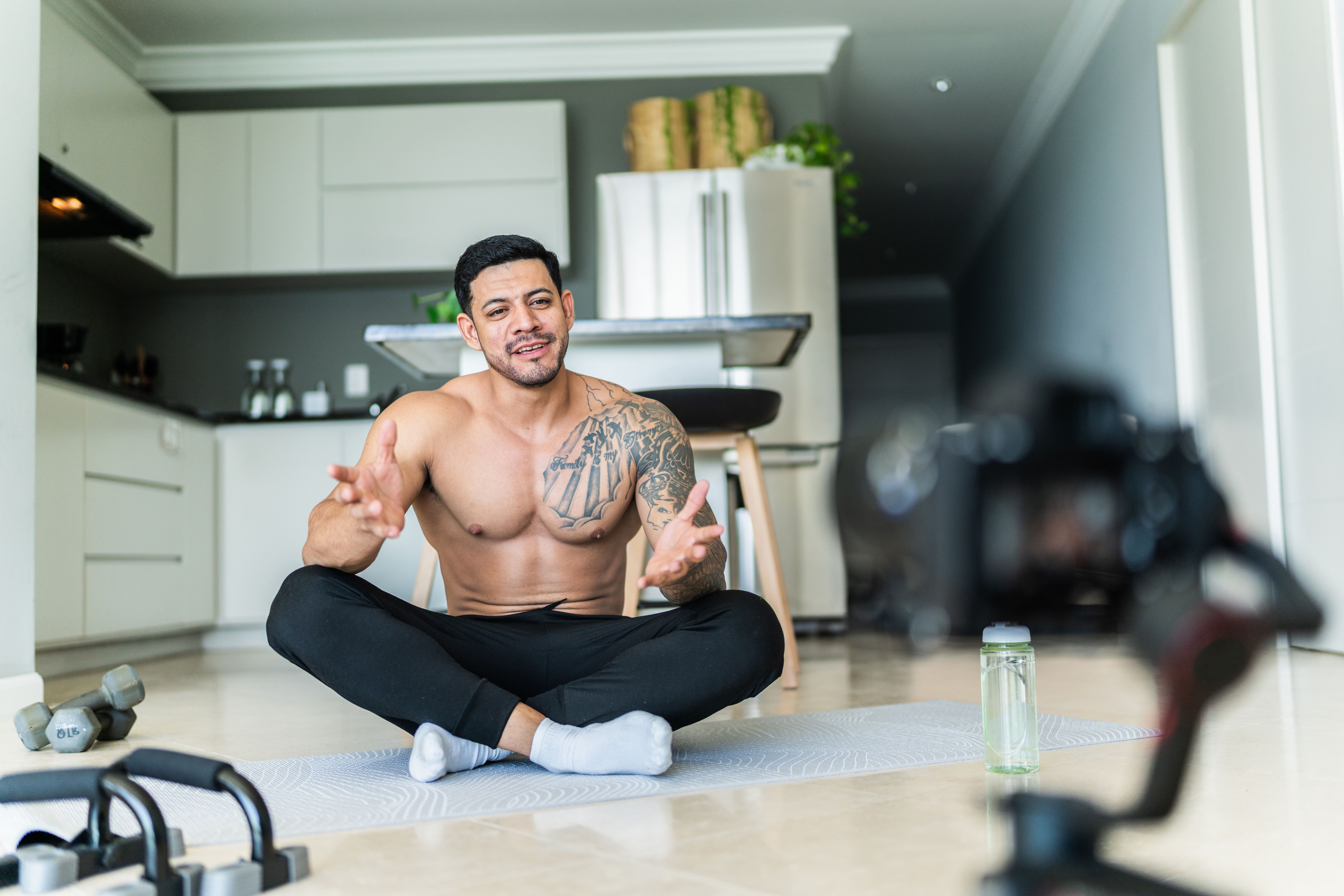 Fitness young man recording vlog and talk at home