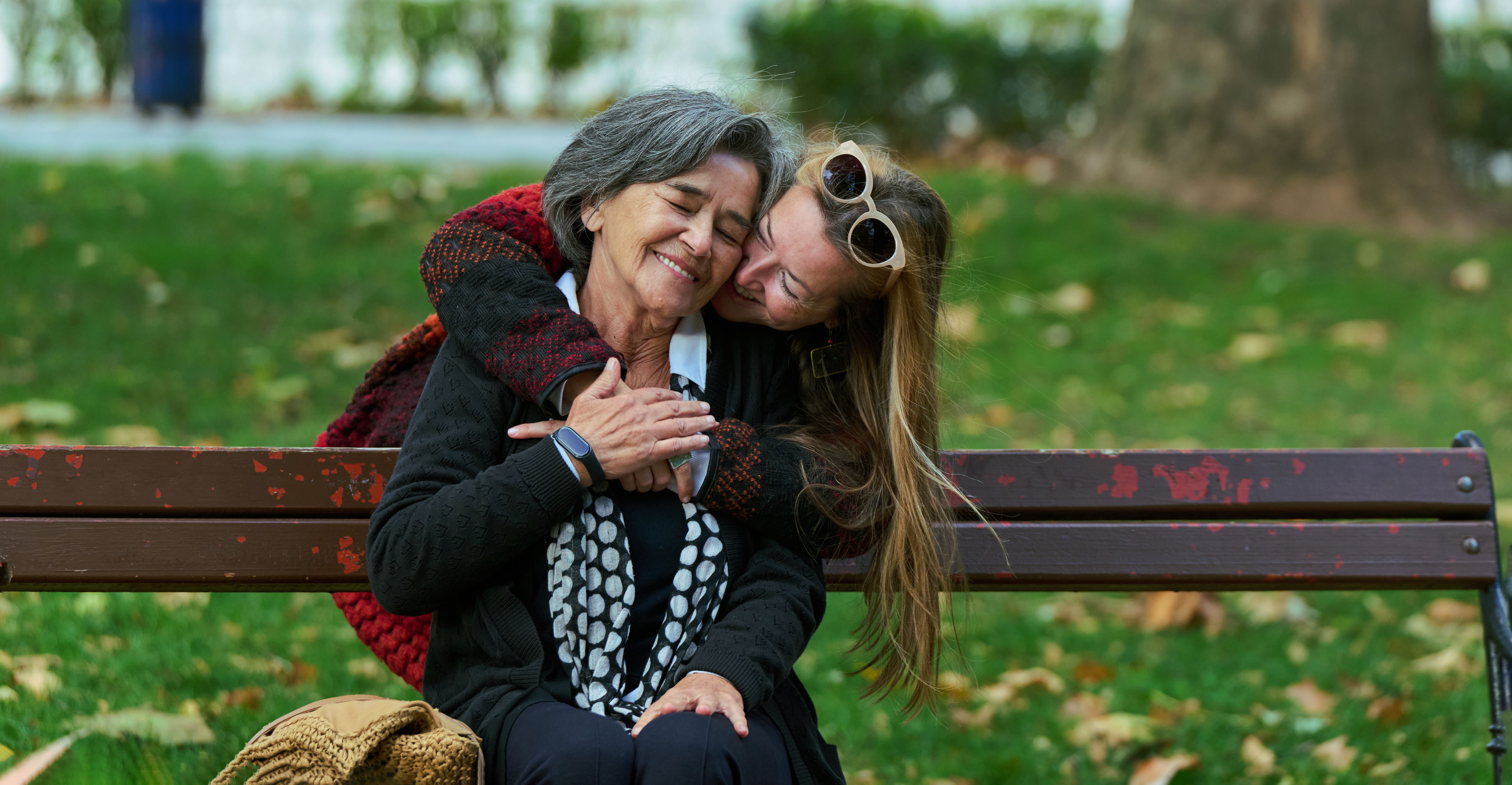 Embracing Generations: A Daughter's Love and Support for Her Senior Mother on a Sunny Day in the Park Embracing Generations: A Daughter's Love and Support for Her Senior Mother on a Sunny Day in the Park