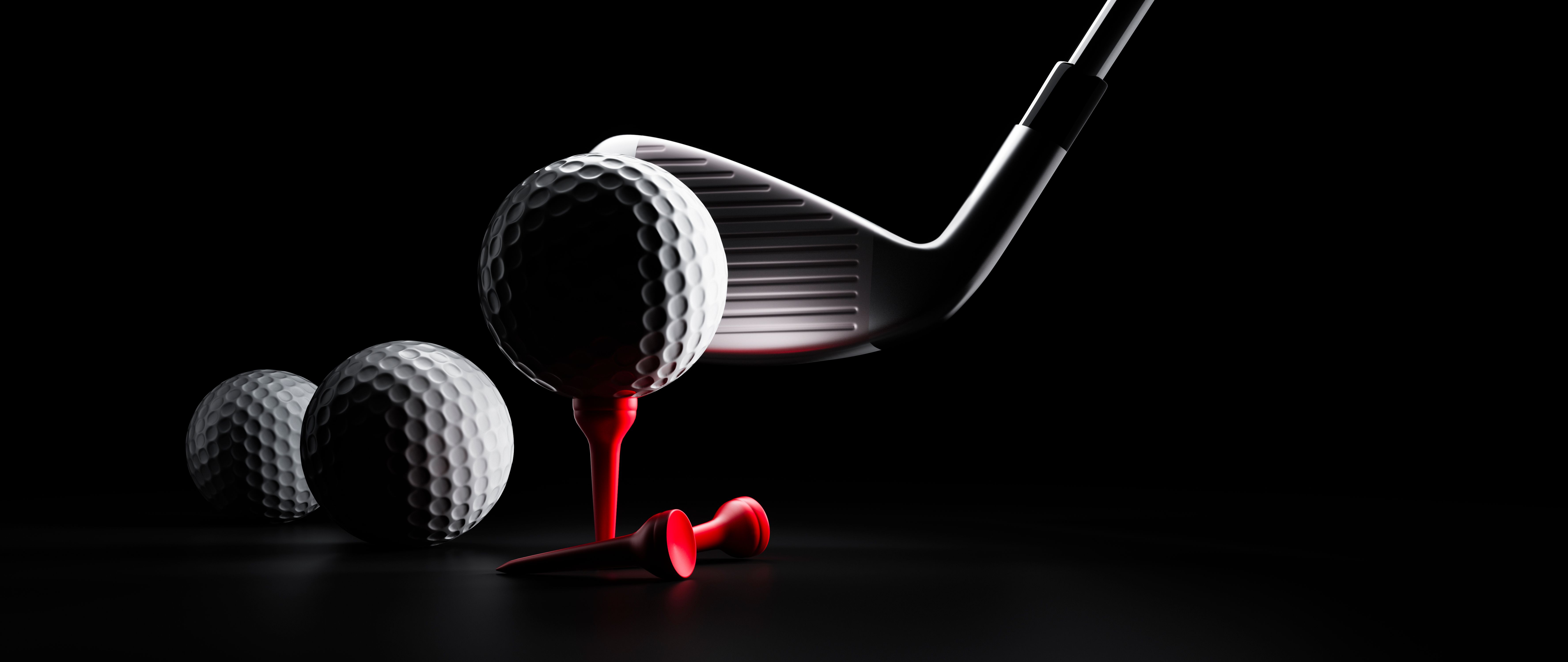 Group of golf balls with driver and red tee