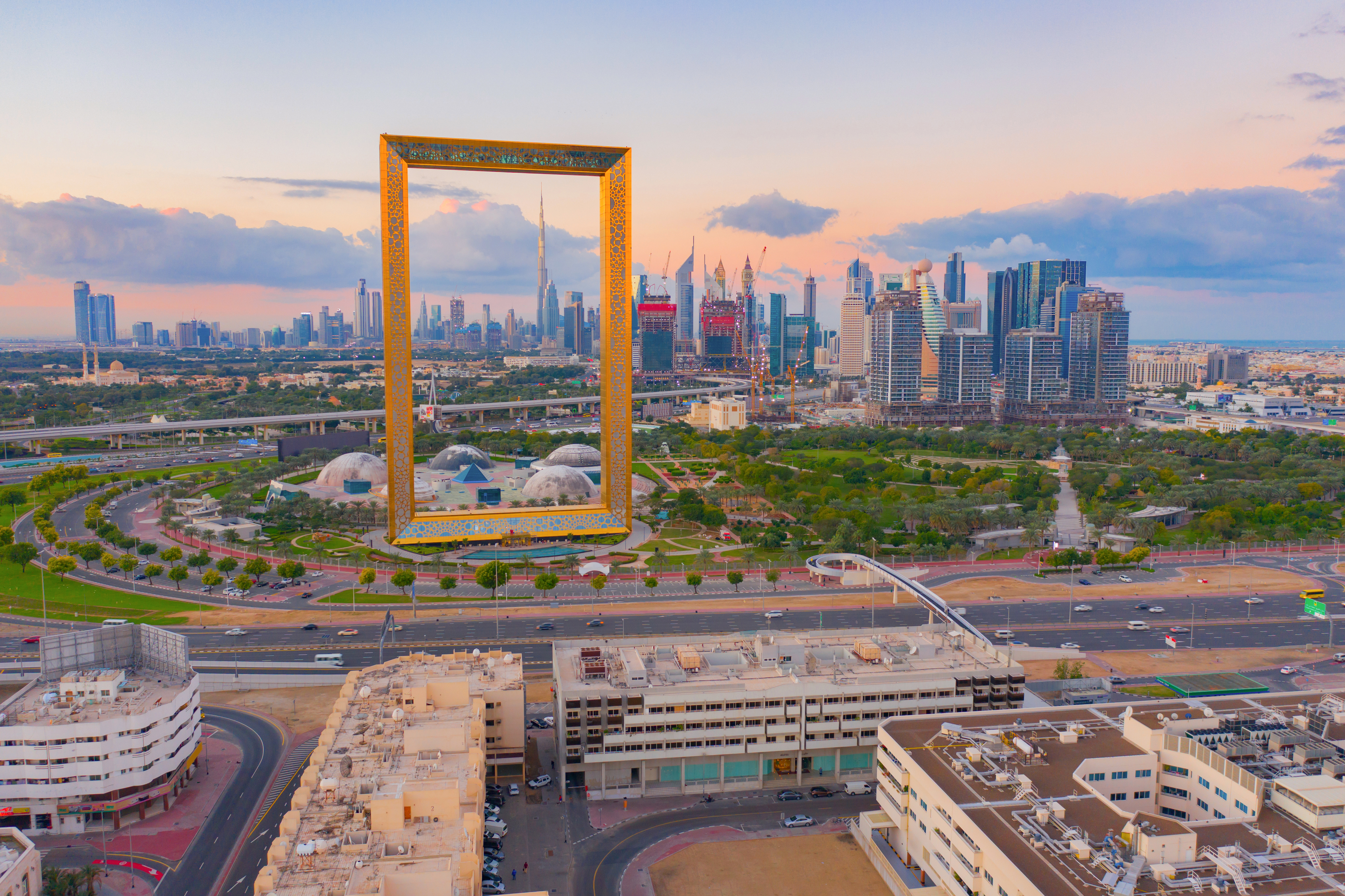 Aerial view of Dubai Frame, Downtown skyline, United Arab Emirates or UAE. Financial district and business area in smart urban city. Skyscraper and high-rise buildings at sunset.
