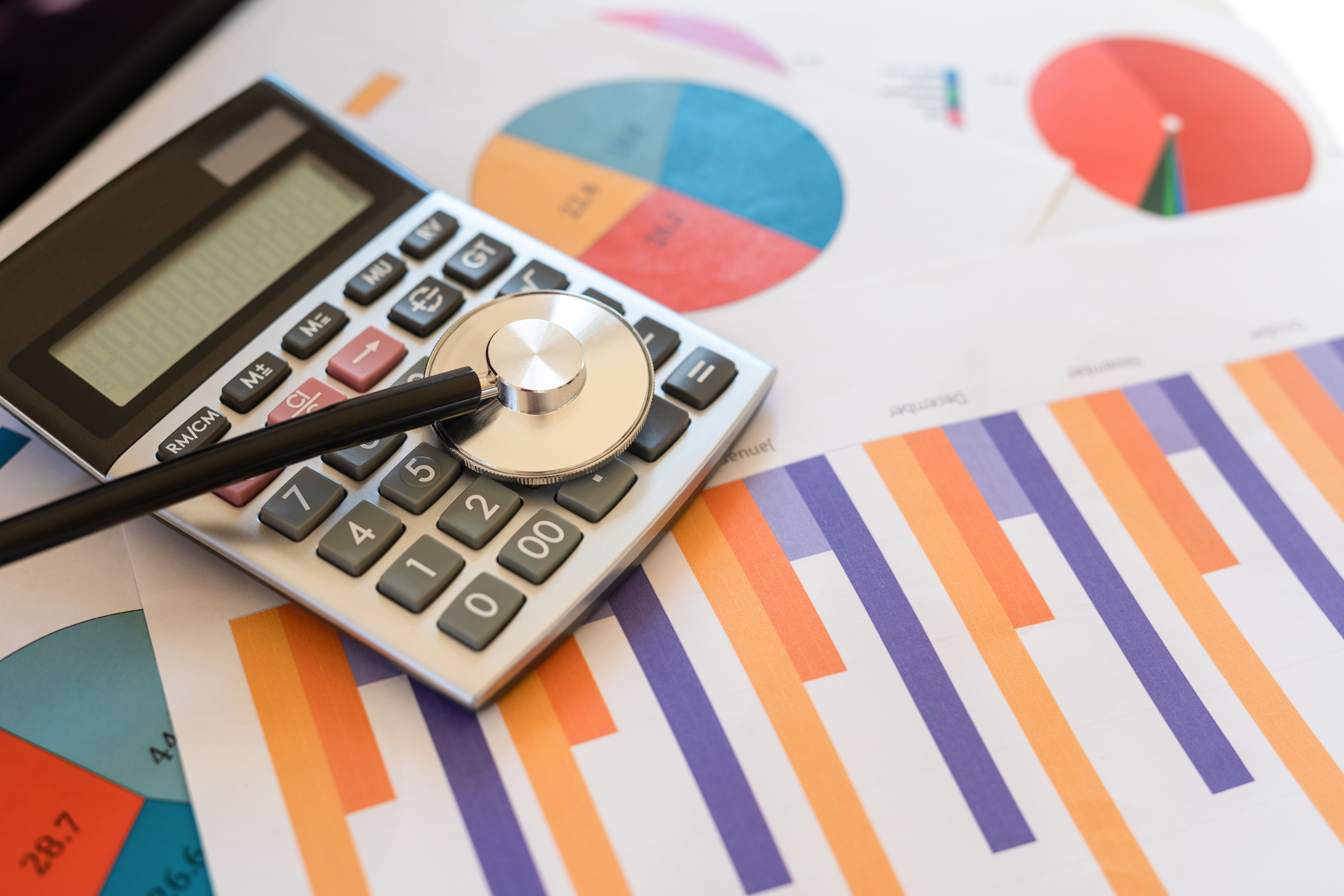 Financial statement with stethoscope and calculator
