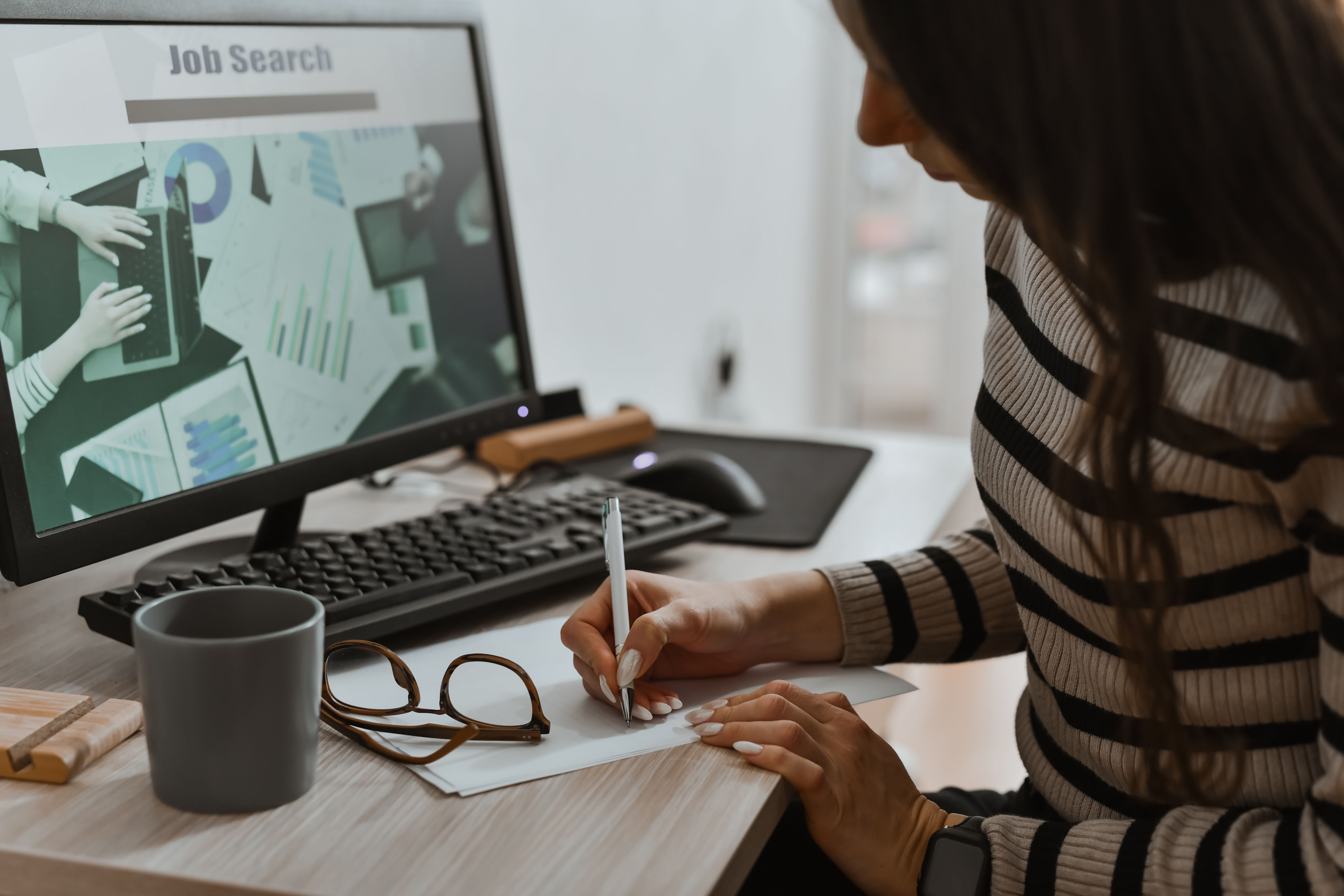 Female Writing Down on Paper Job Opportunities She Found Online Female Writing Down on Paper Job Opportunities She Found Online