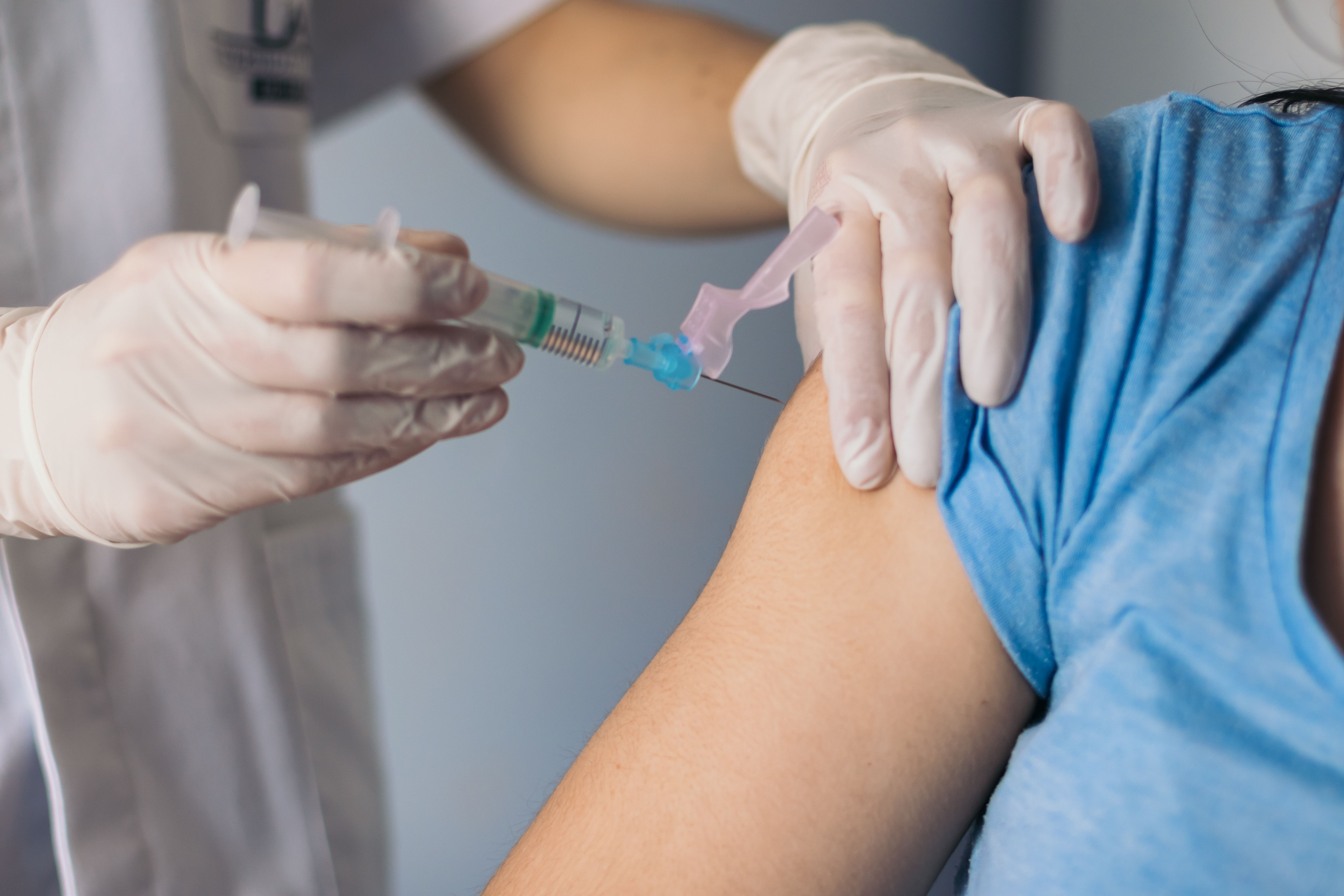 nurse giving a vaccine to a patient. Close-up