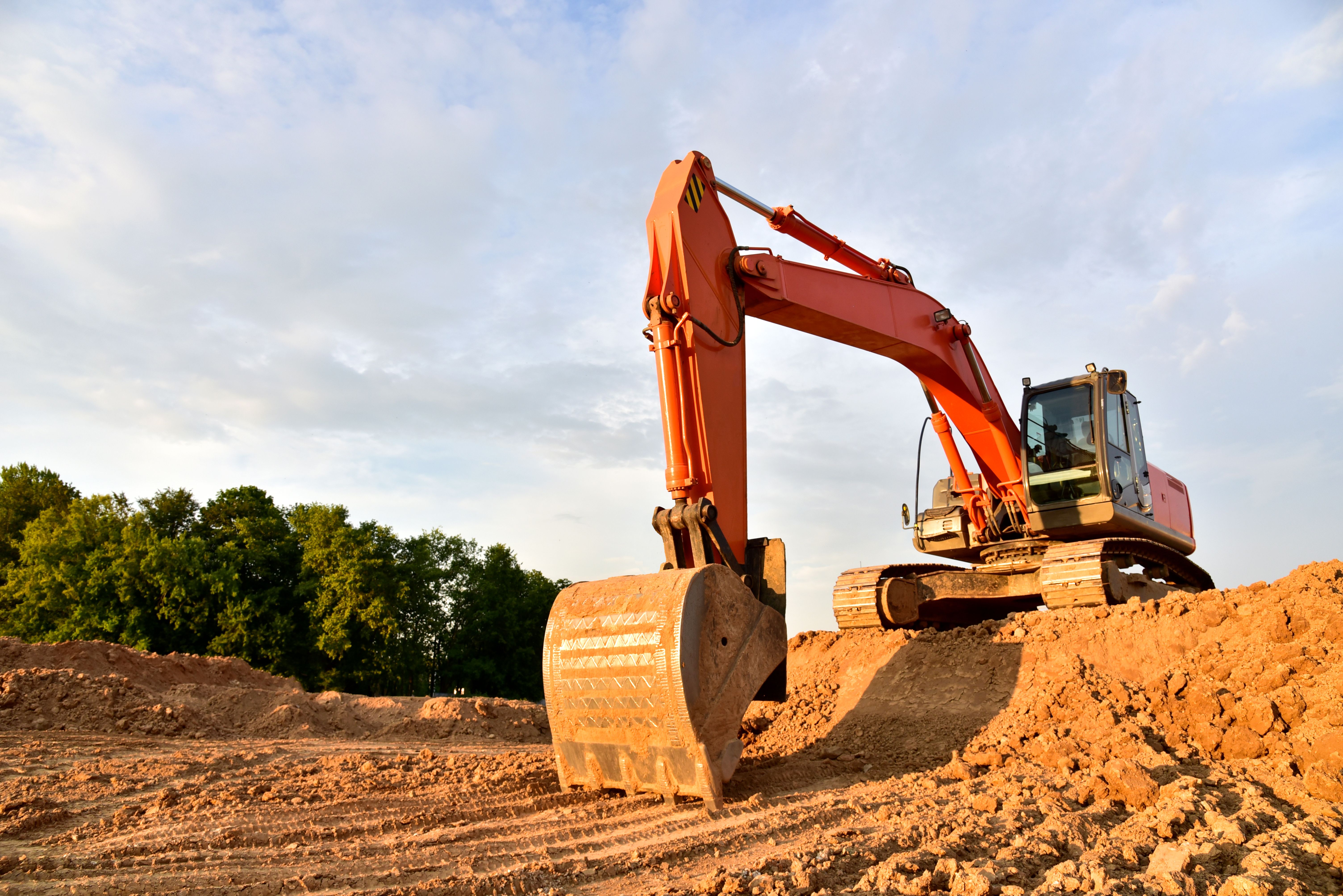 Excavator dig sand at the open-pit. Heavy machinery working in the mining quarry.