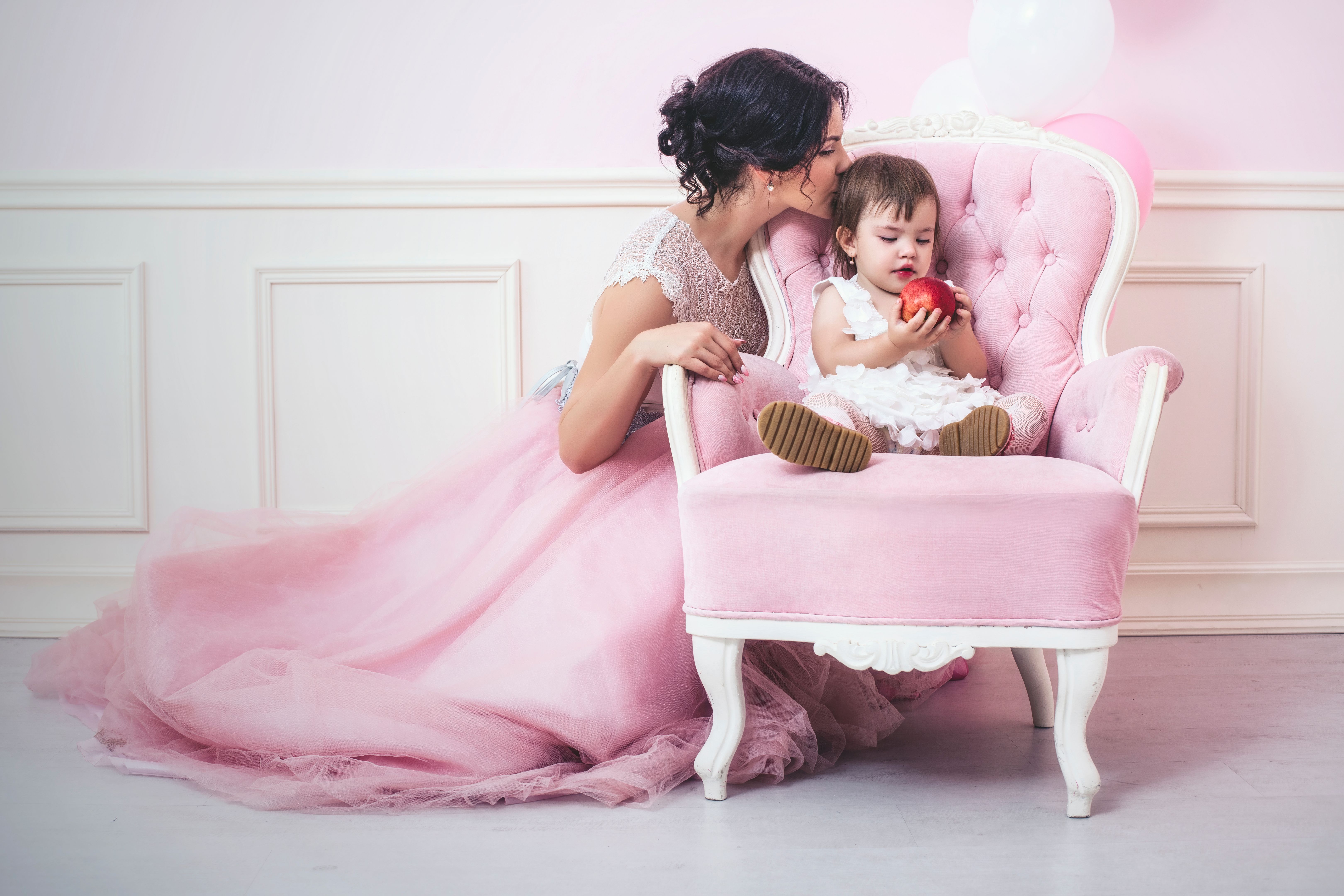 Mother and daughter a beautiful and happy pink interior with