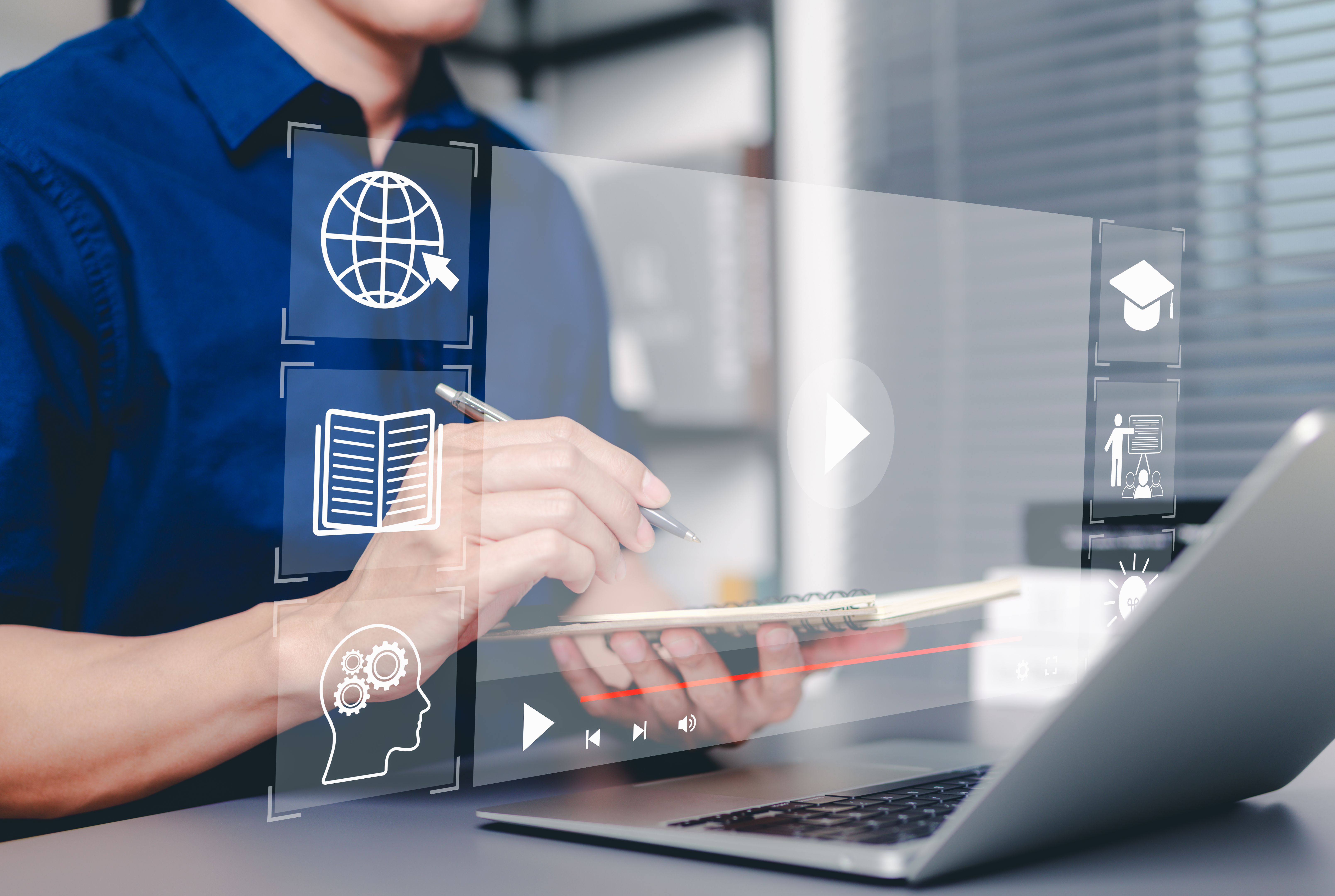 Online education and e-learning concept. Man taking notes while using laptop with online education icon, learning, knowledge sharing, educational tools, training, webinar on internet, digital courses,