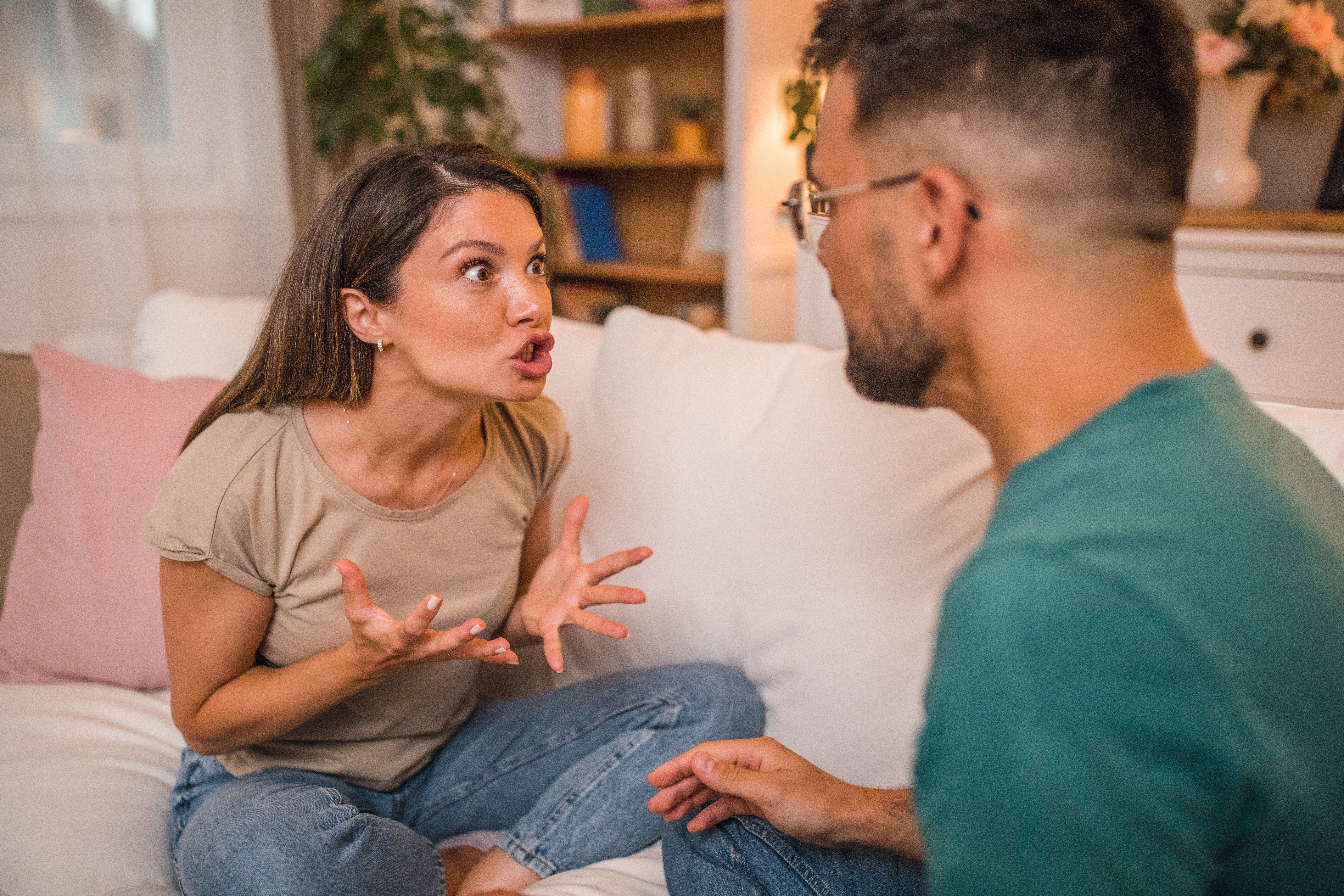 A loving couple in a serious argument, shouting and trying to outvote each other A loving couple in a serious argument, shouting and trying to outvote each other