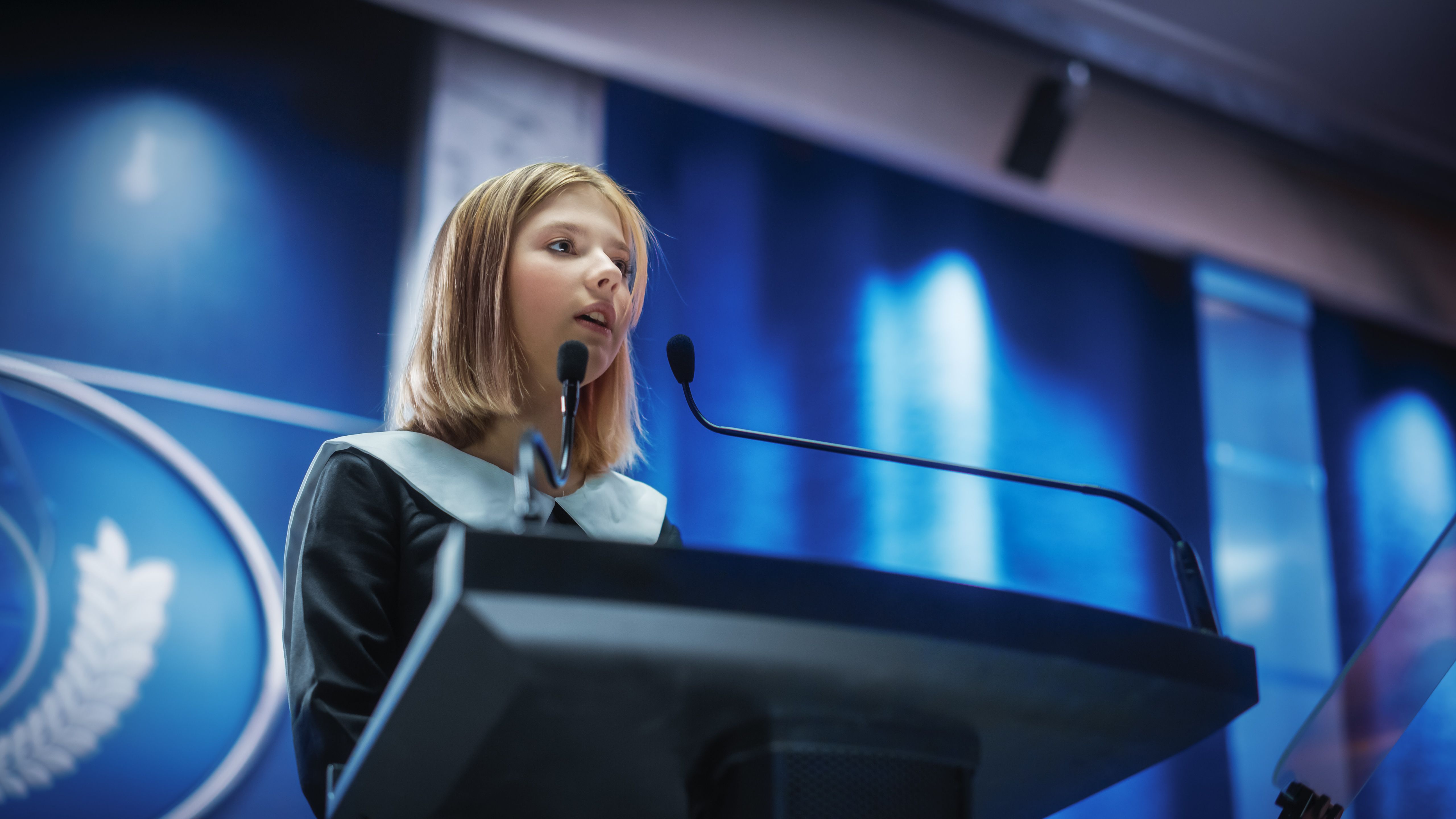 Portrait of an Young Girl Activist Delivering an Emotional and Powerful Speech at a Press Conference in Government Building. Child Speaking to Congress at Summit Meeting with World Leaders.