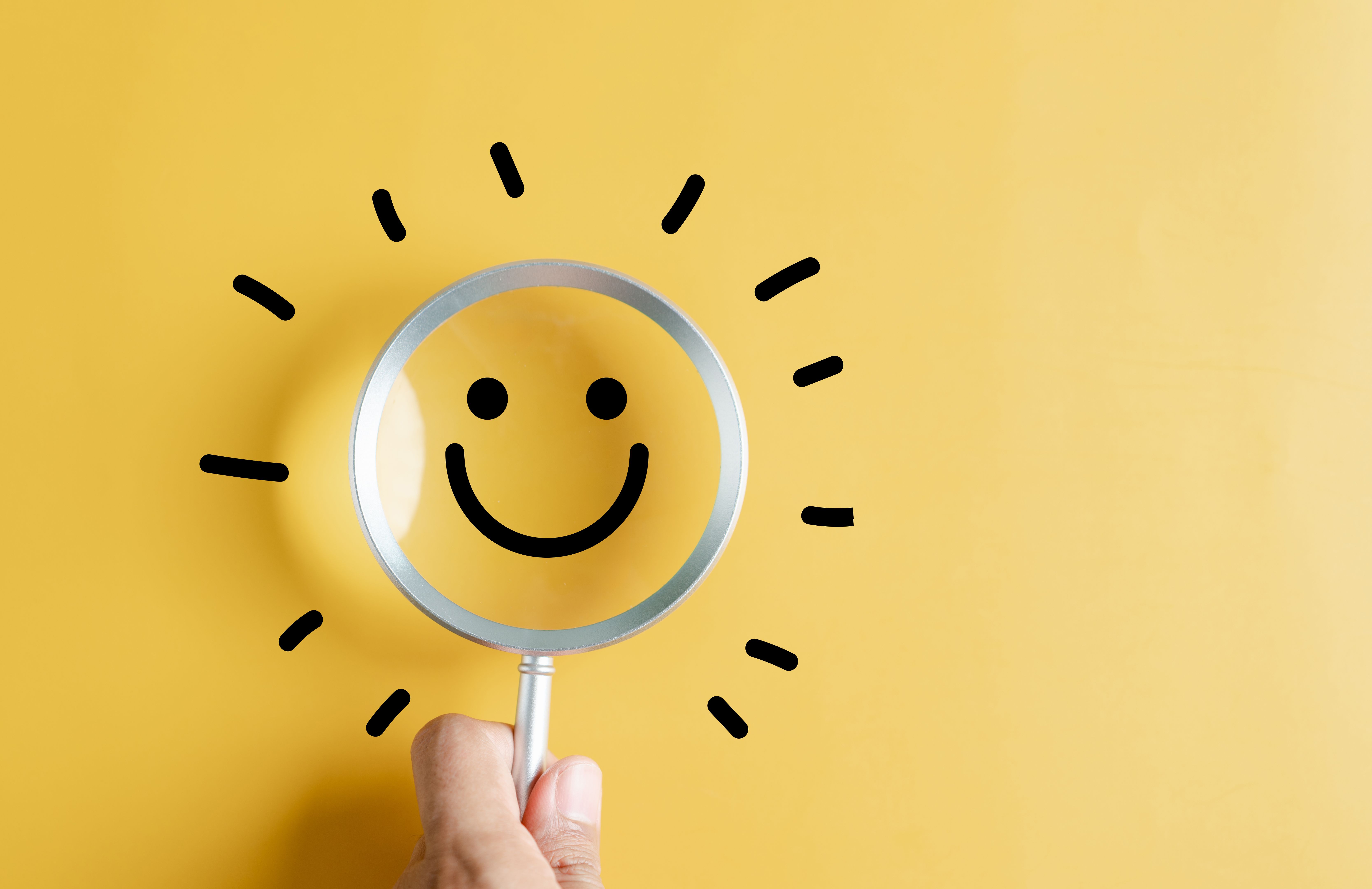 Magnifier focus to smile face emoticon with light bulb smart idea, creativity and solution concept.