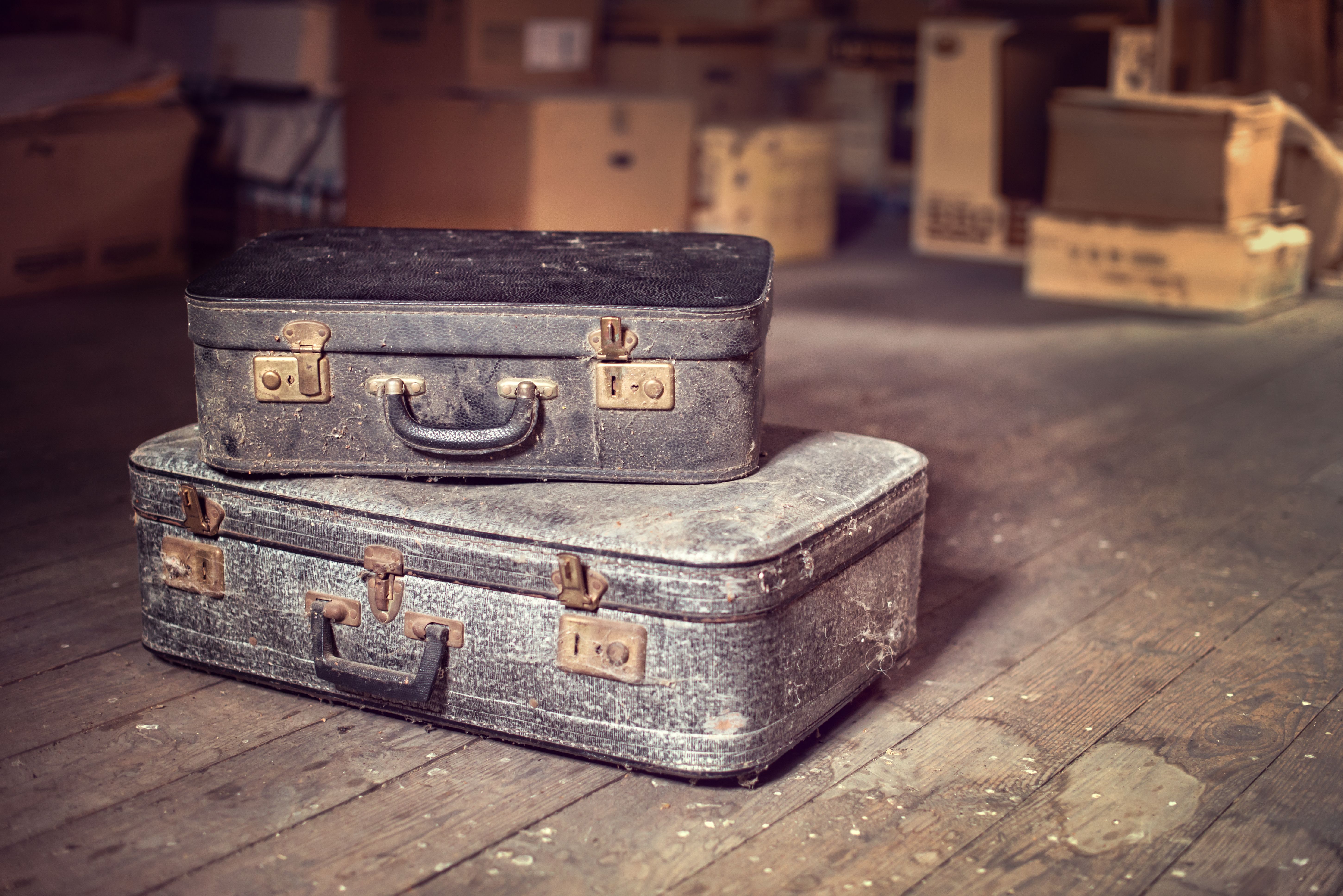 Old vintage suitcases in a dusty attic Old vintage suitcases in a dusty attic