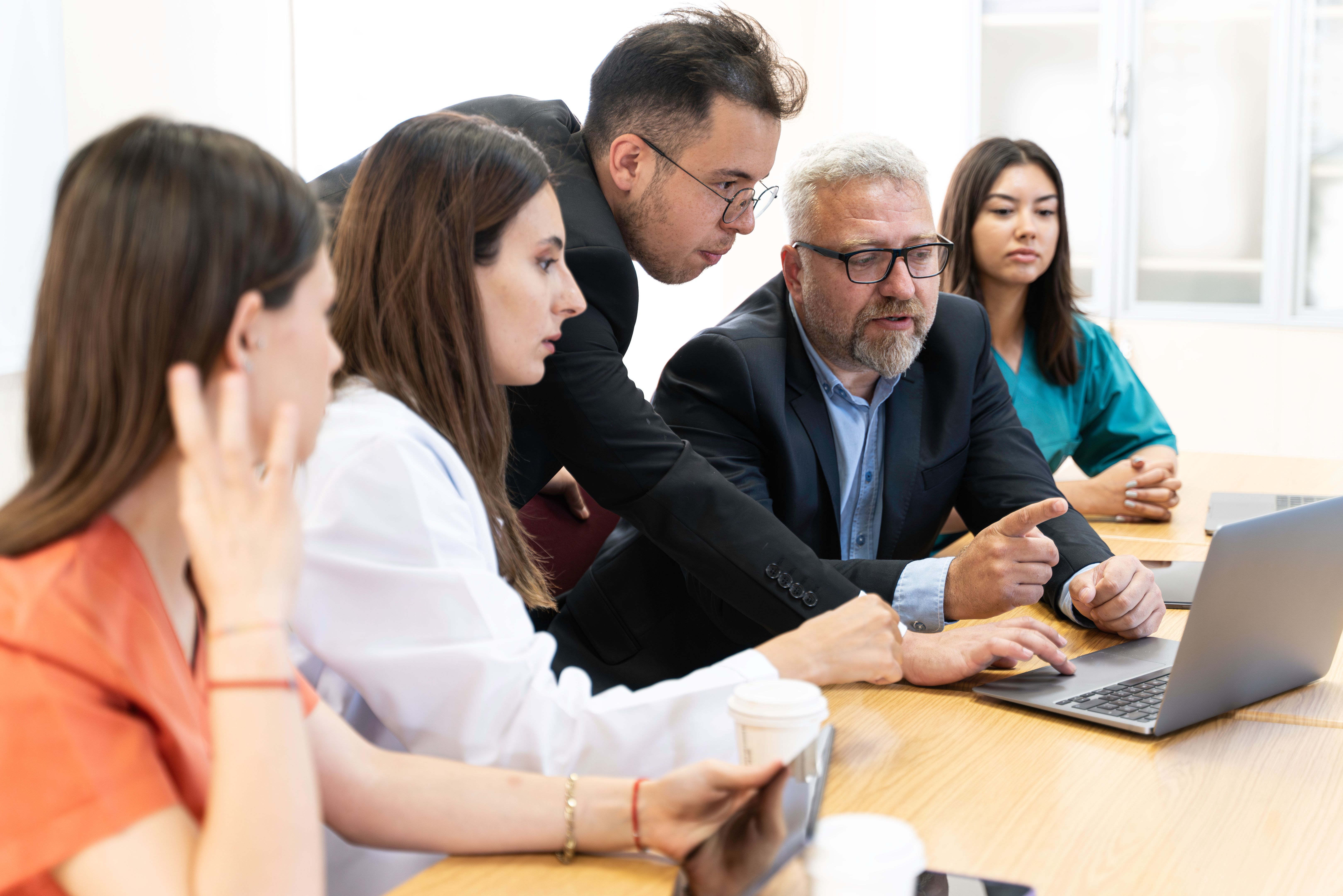 Group of doctors and nurses working together in a conference room at hospital