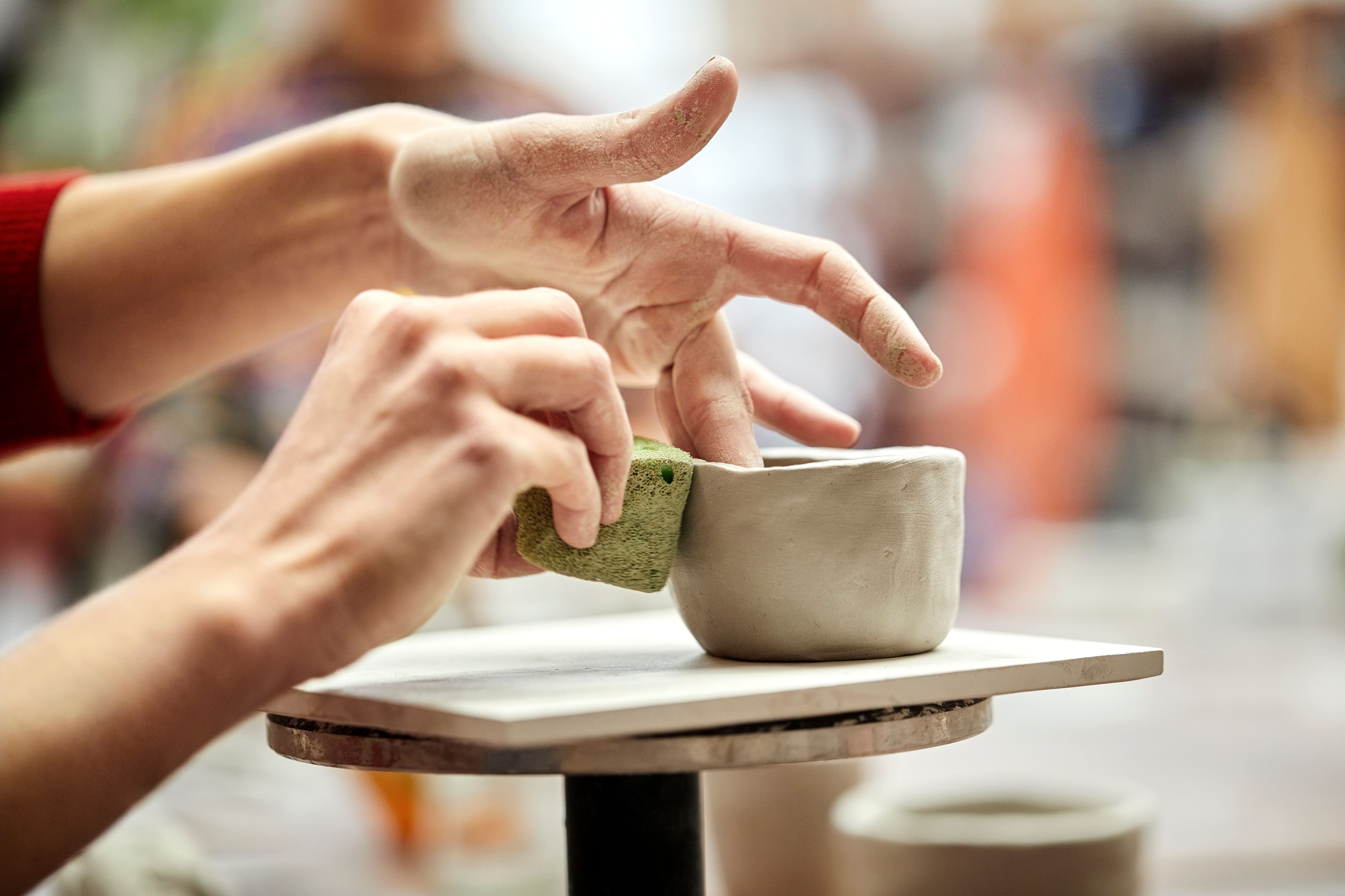 people crafting pottery