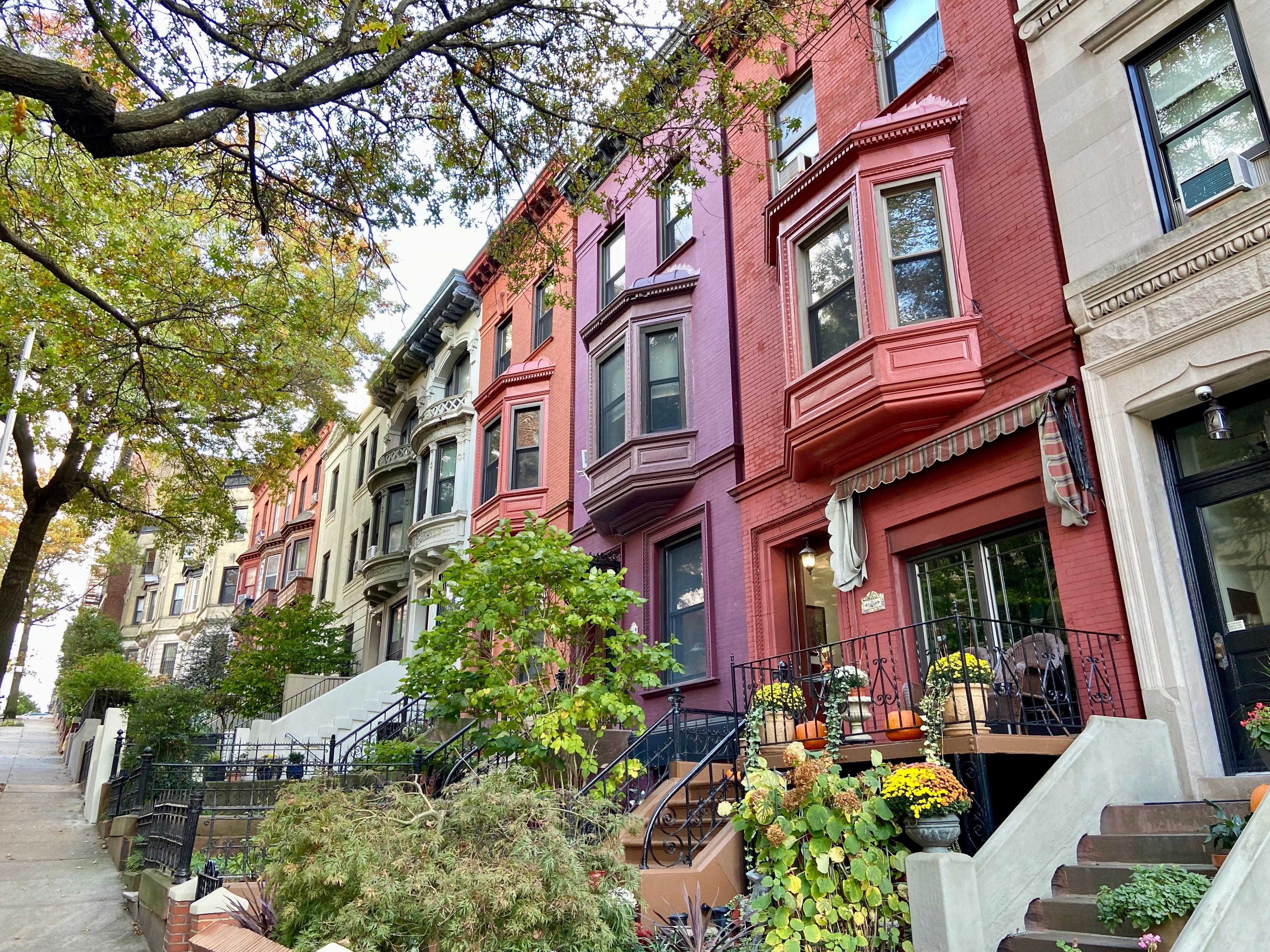 Row of colorful townhouses in Harlem, NYC