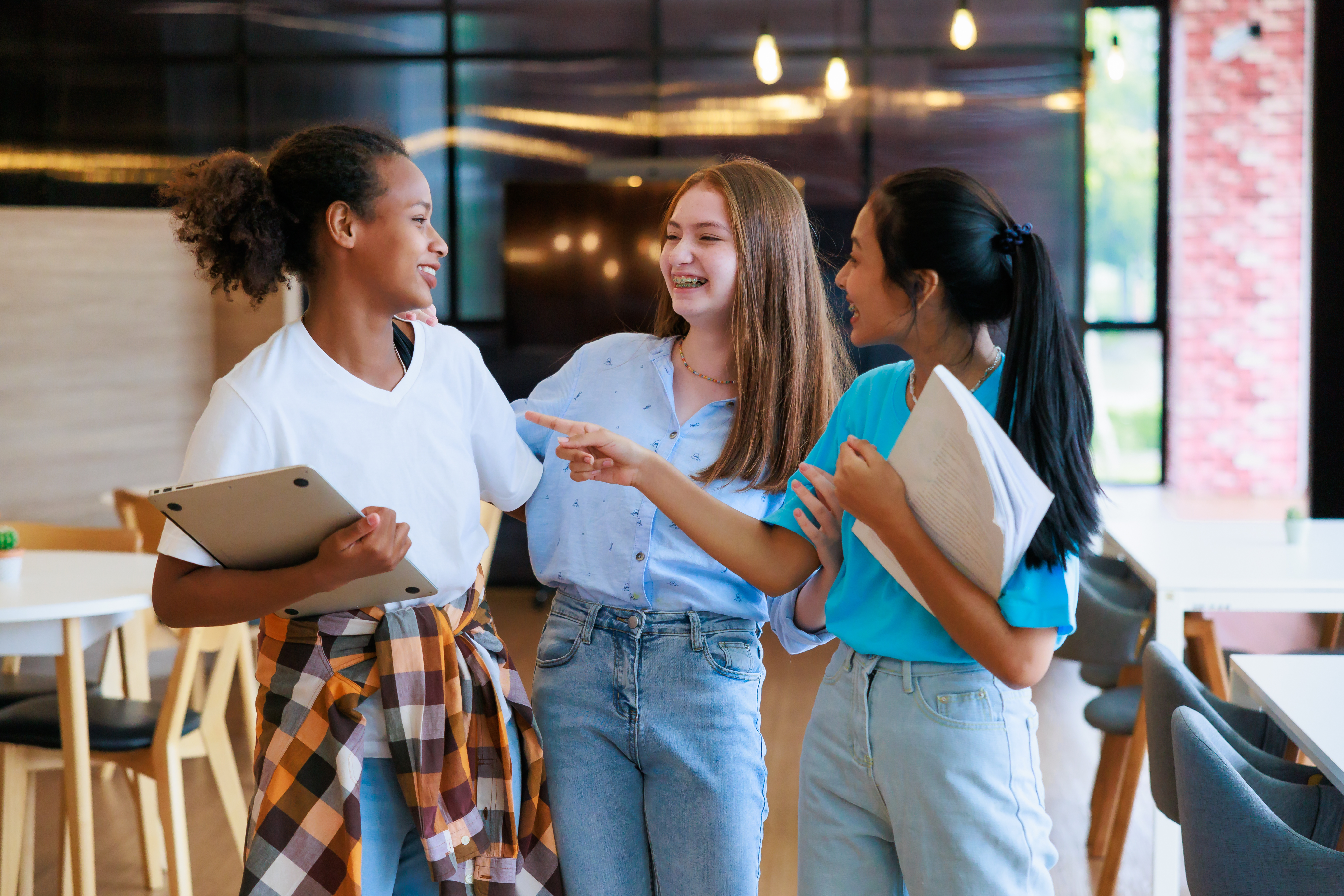 Group of teenager student walking to leaning in library of school. University Library education and Student Learning concept.
