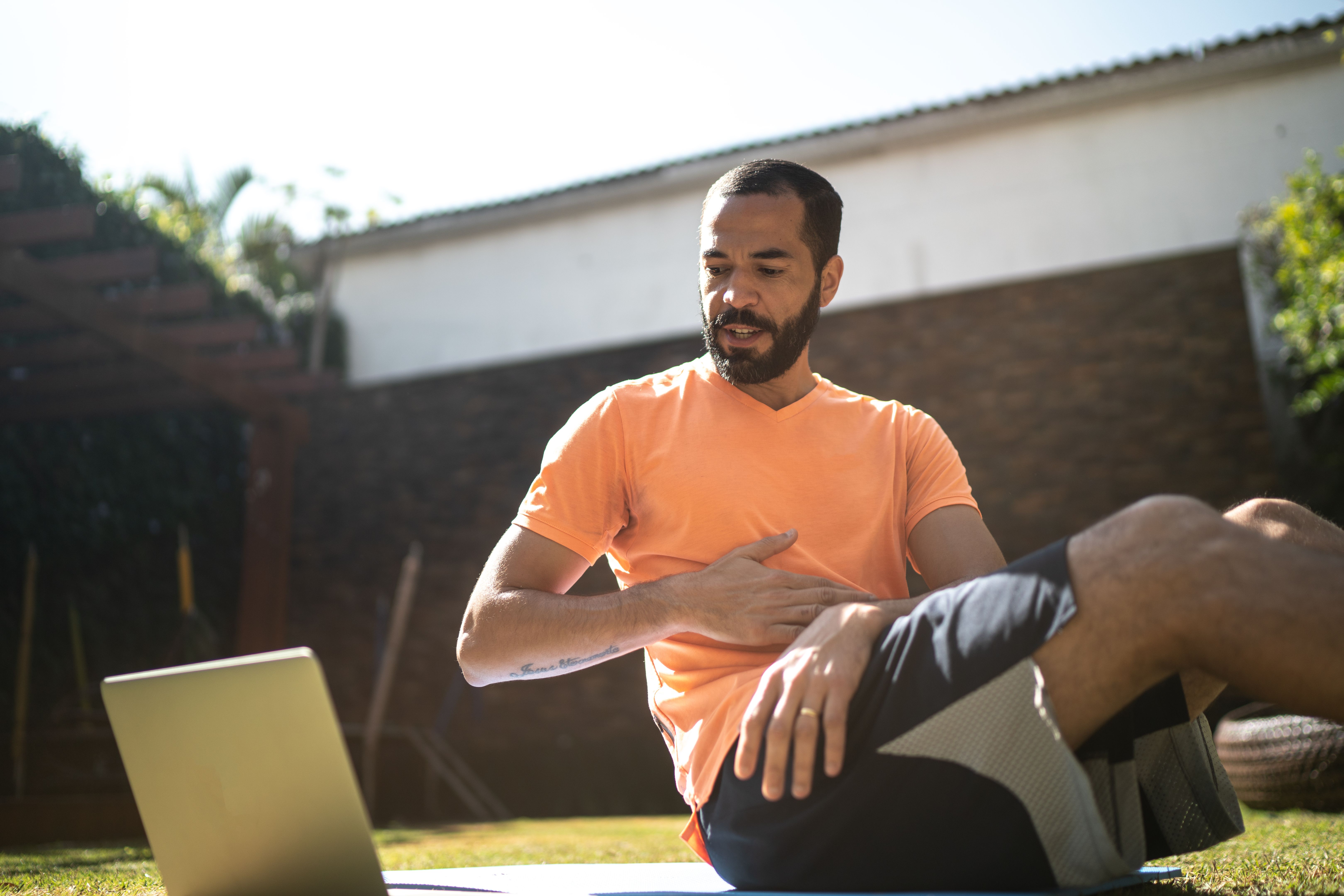 Man doing a virtual exercise class Man doing a virtual exercise class