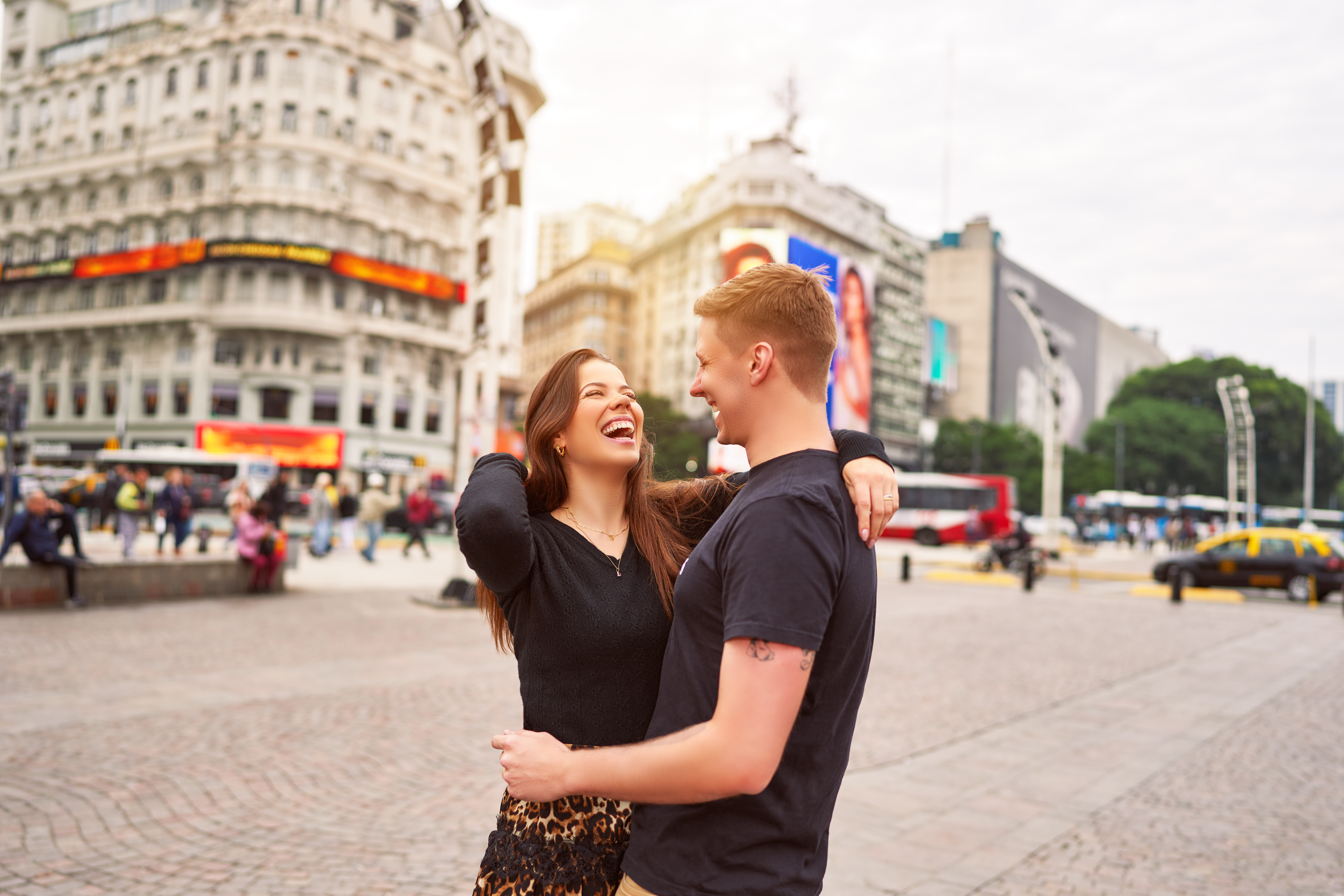 happy young adult heterosexual couple smiling hugging in the city of Buenos Aires
