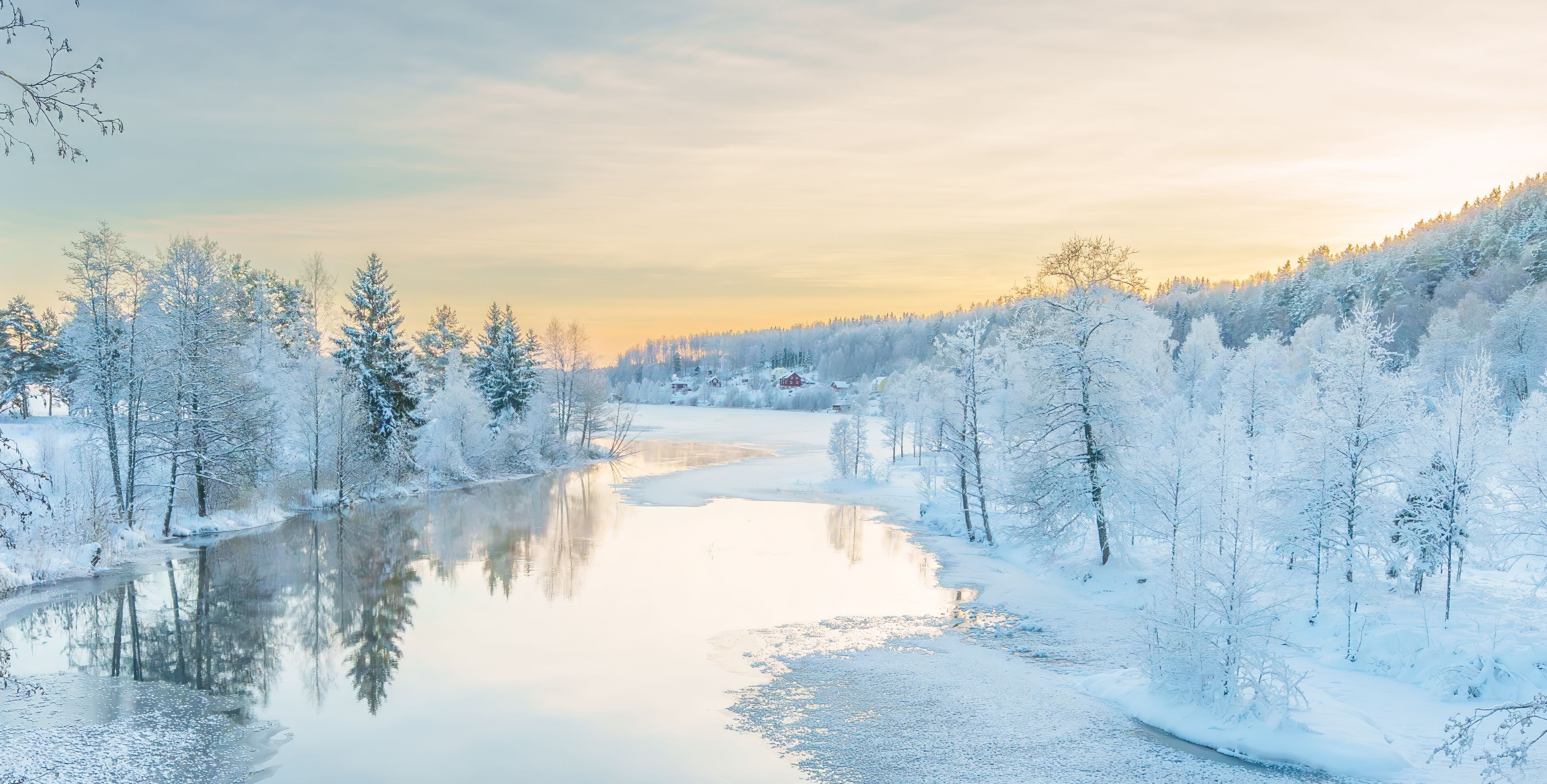 River flowing through the winter forest in Sweden