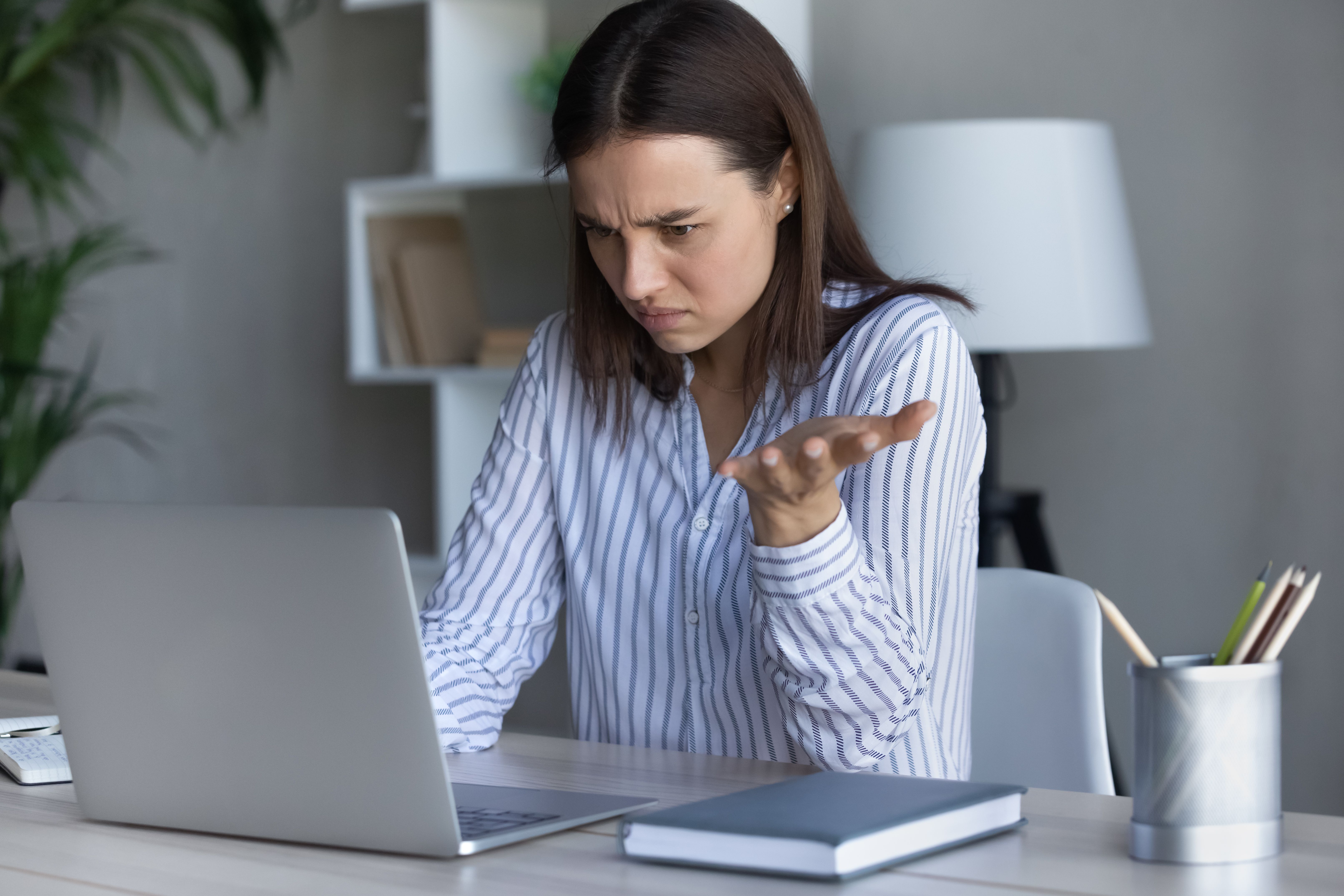 Confused young businesswoman looking at computer screen. Confused young businesswoman looking at computer screen.