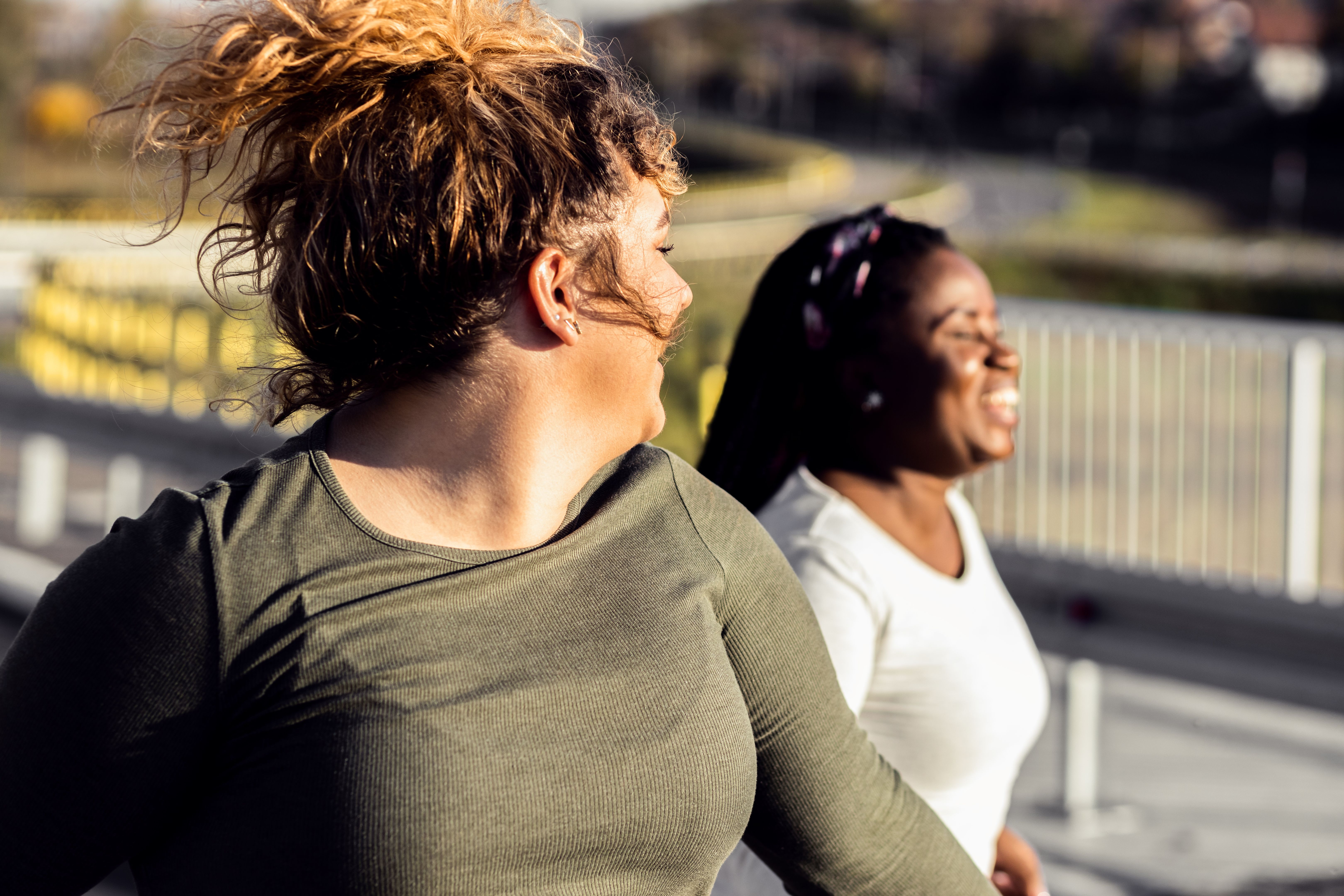Two young plus size women jogging together. Two young plus size women jogging together.