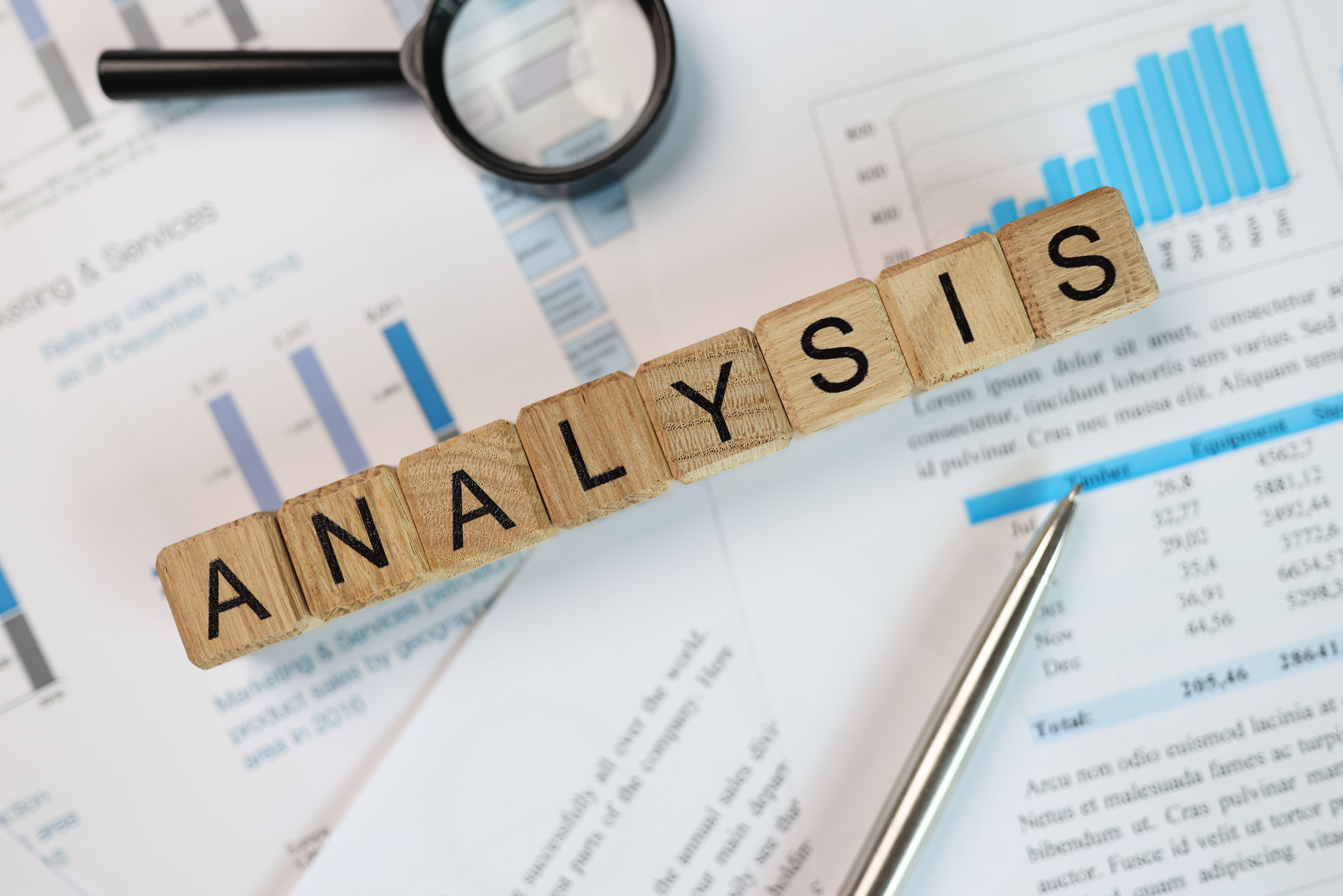 Word Analysis made of wooden cubes on accounting papers