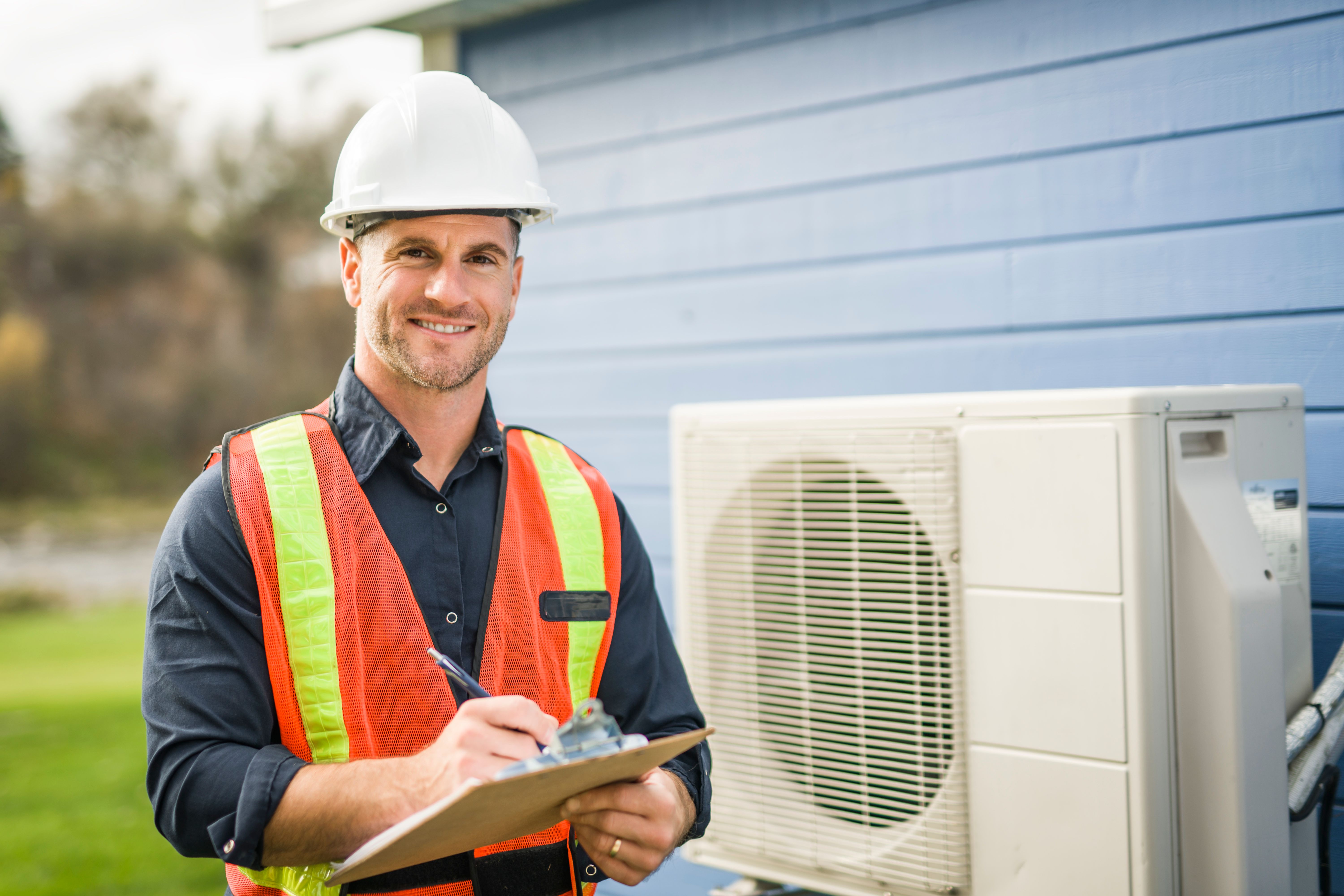 technician working on air conditioning or heat pump outdoor unit