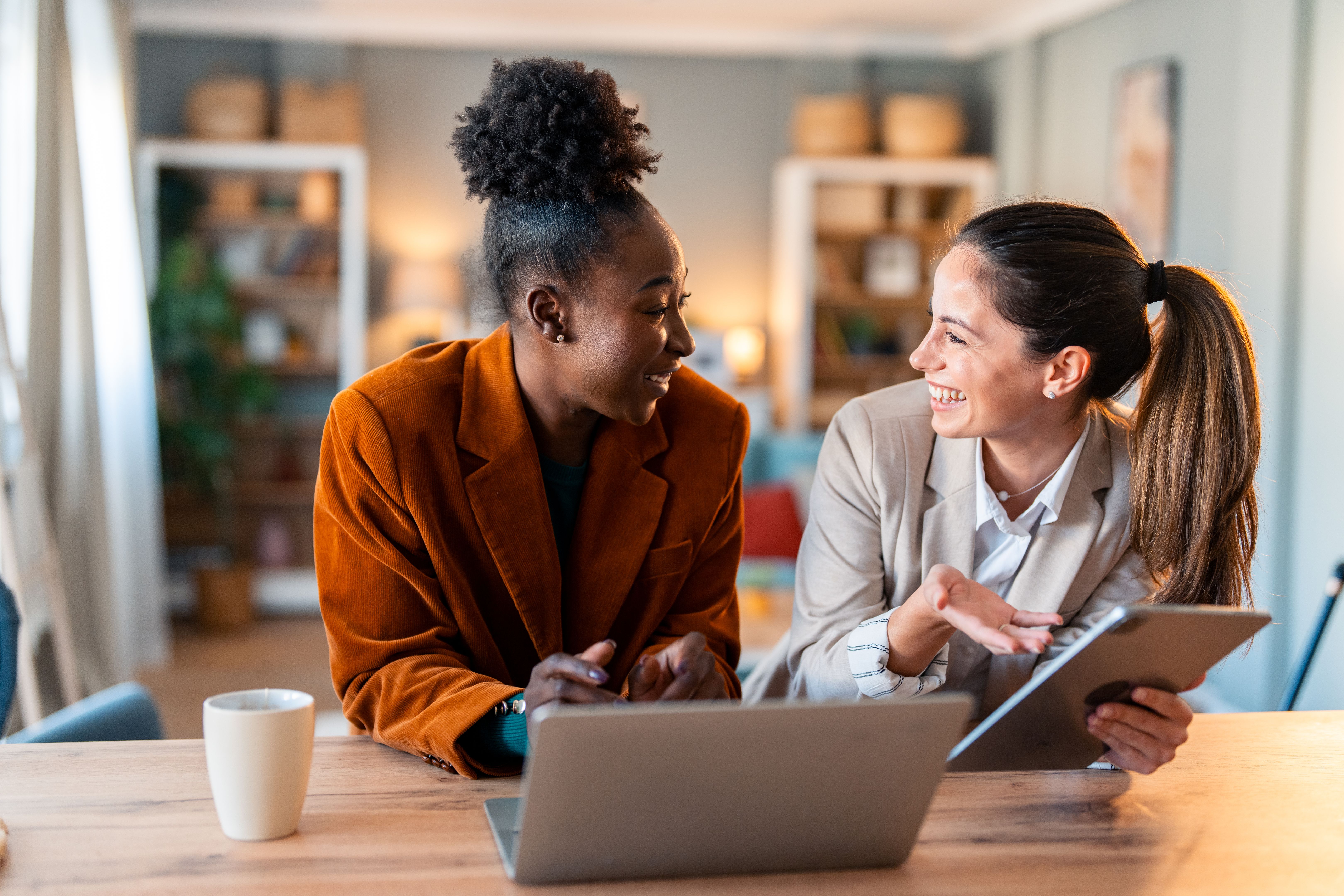 Diverse Business Partners Planning Strategy With Digital Devices At Home
