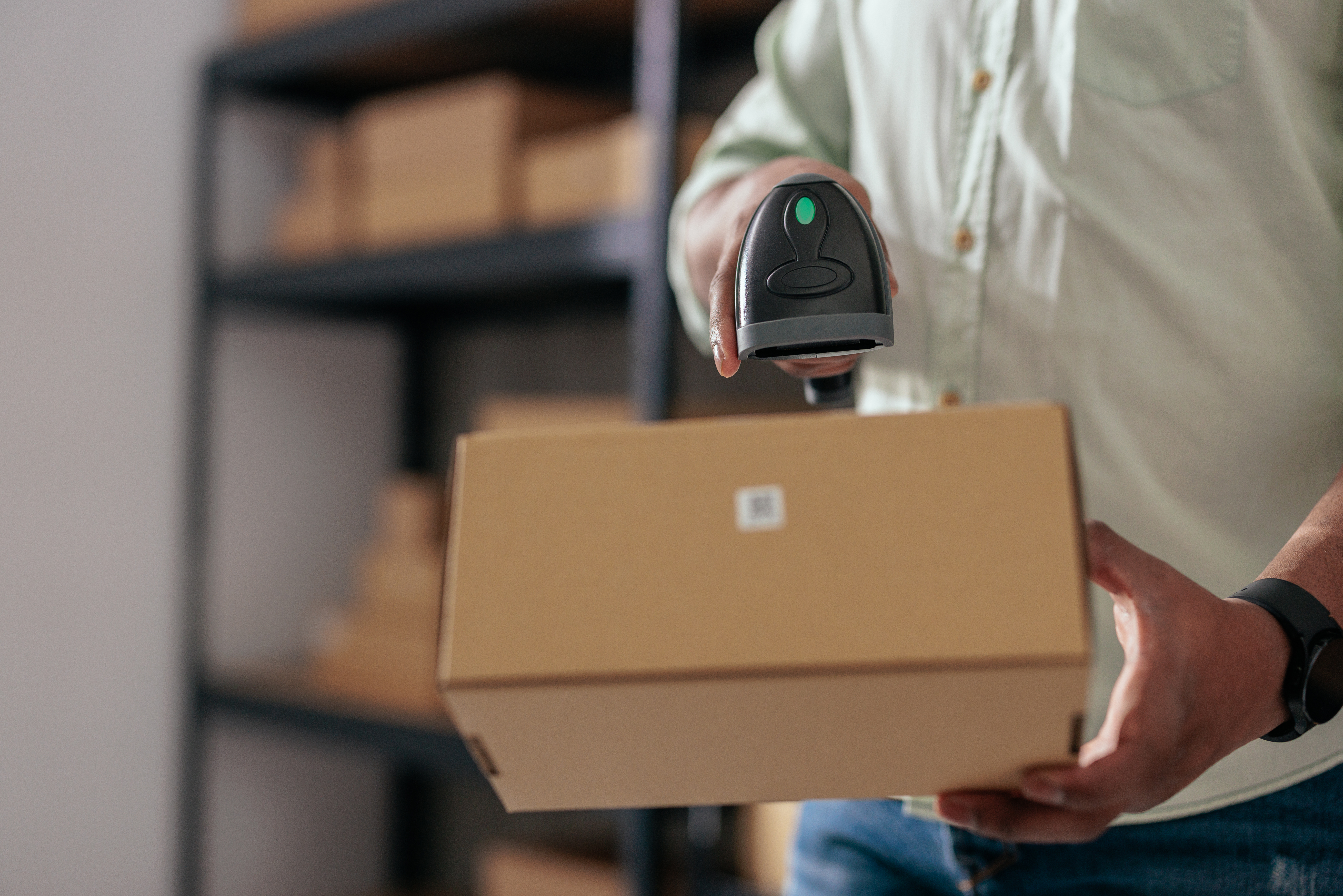Close-up of package scanning process in warehouse Close-up of package scanning process in warehouse