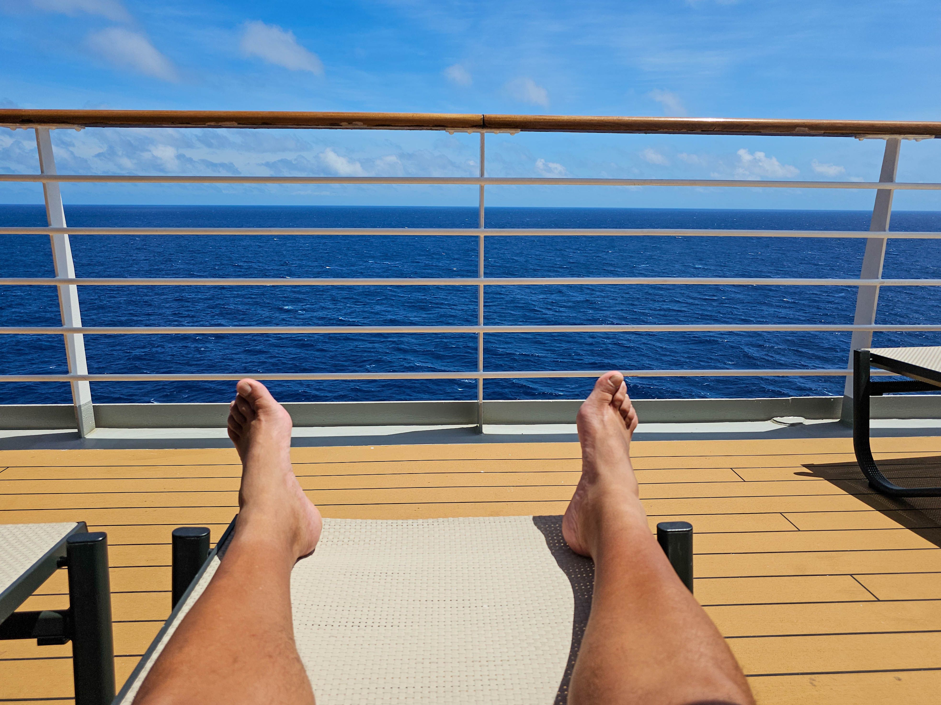 Low Section Of Man Relaxing In Swimming Pool