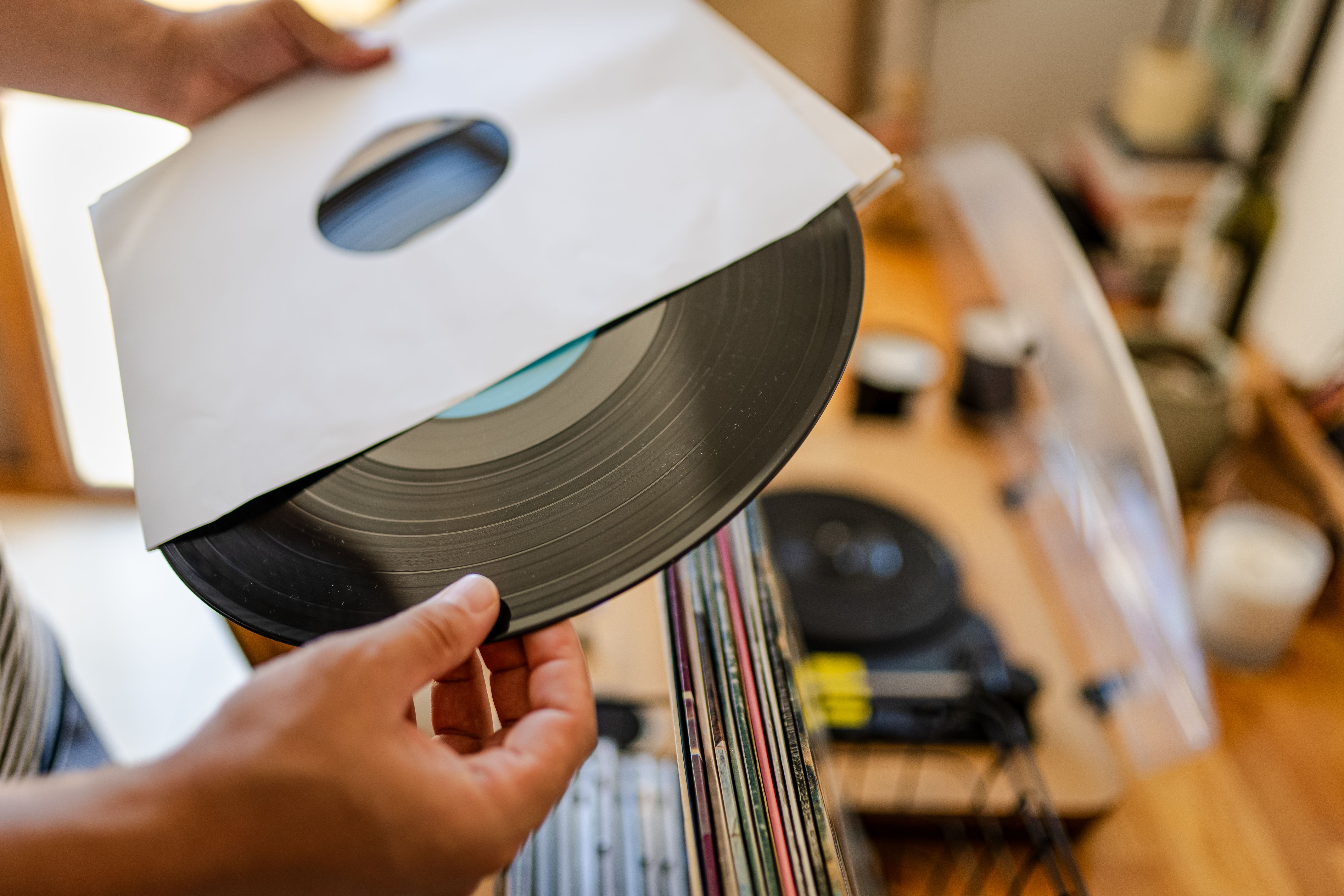 Millennial man choosing Vinyl record from his collection