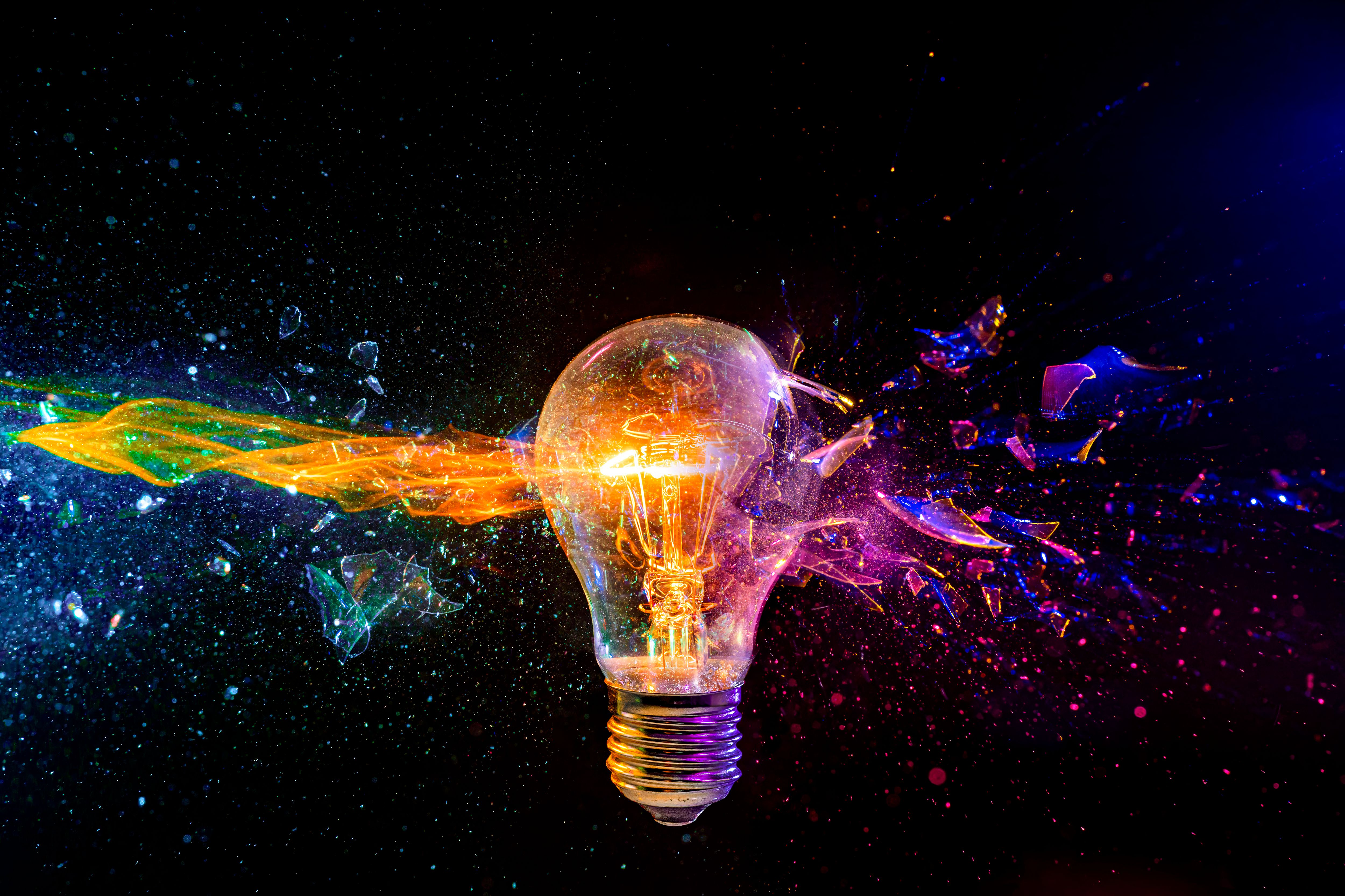 Exploding light bulb with colorful fragment splash Exploding light bulb with colorful fragment splash