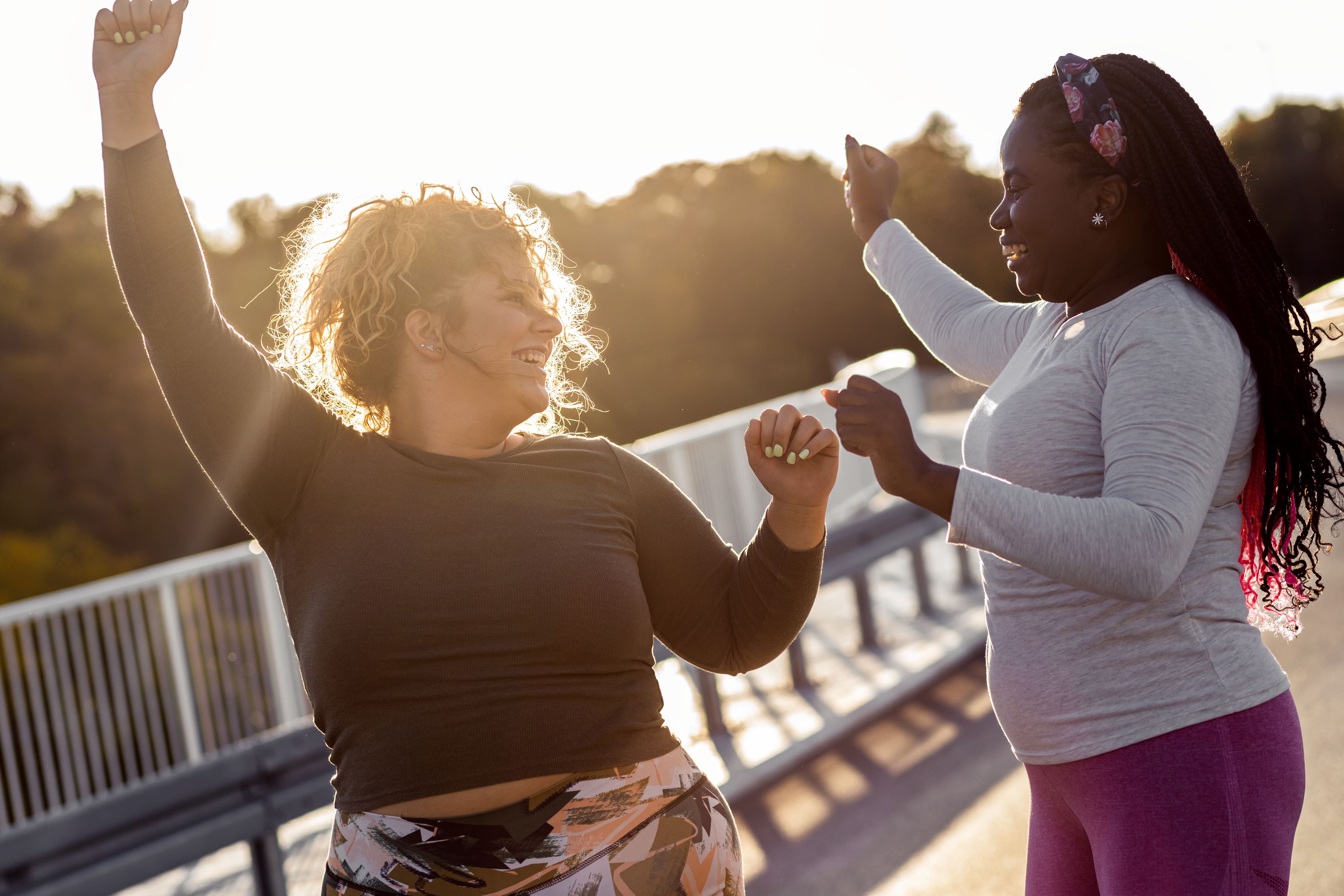 Two young plus size women jogging together.