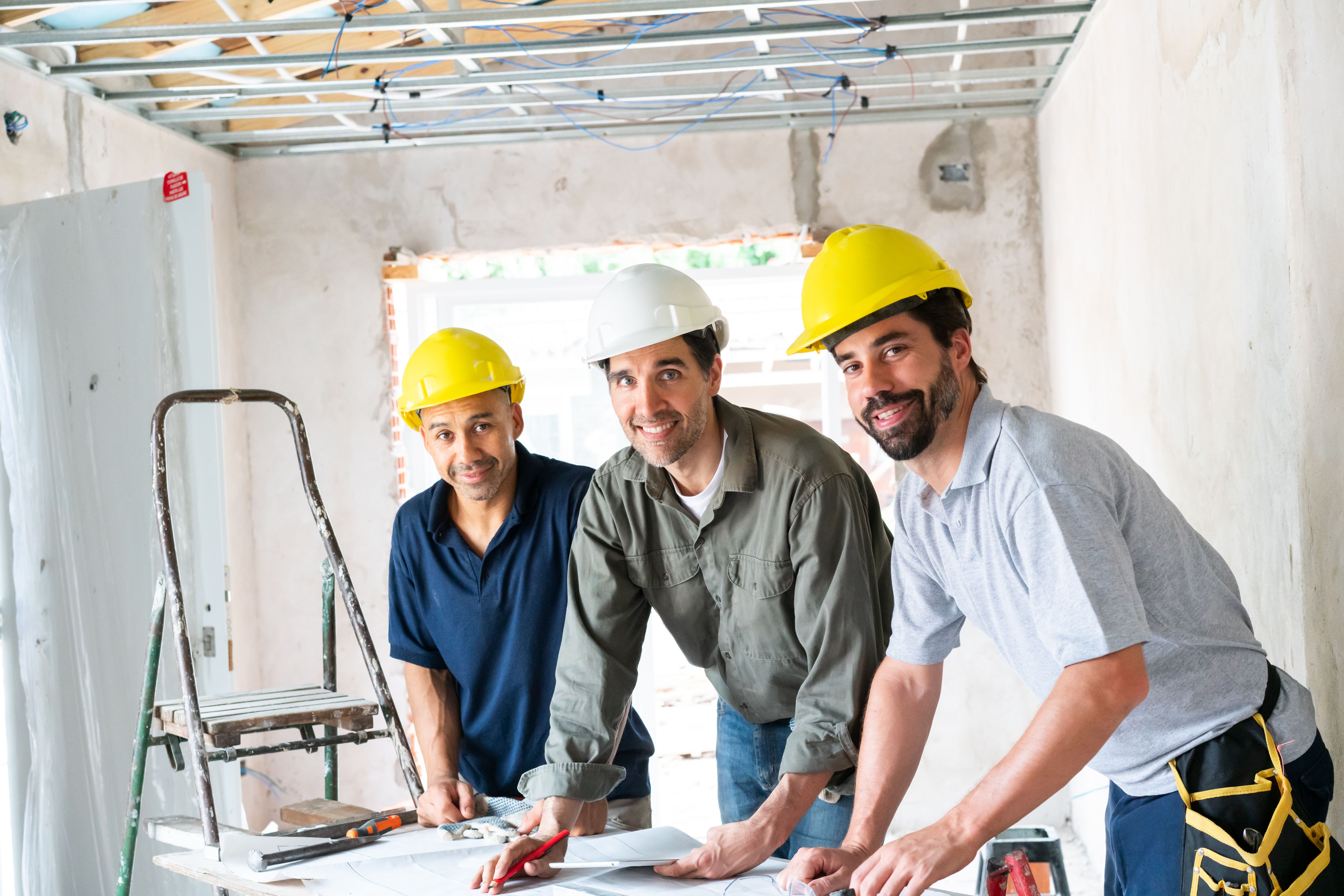 Team of Construction Workers Collaborating on Site