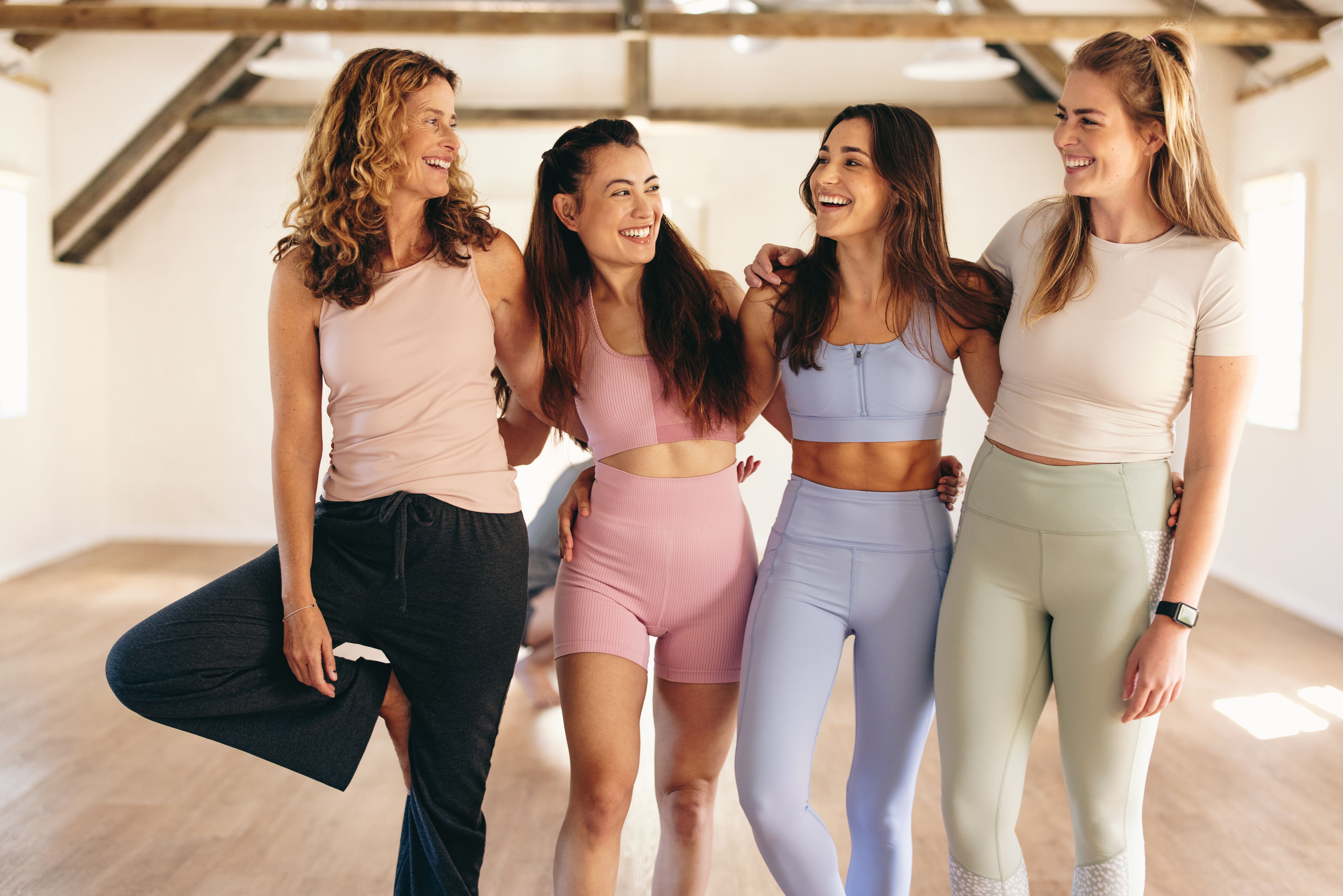 Group of women standing together in a yoga studio Group of women standing together in a yoga studio