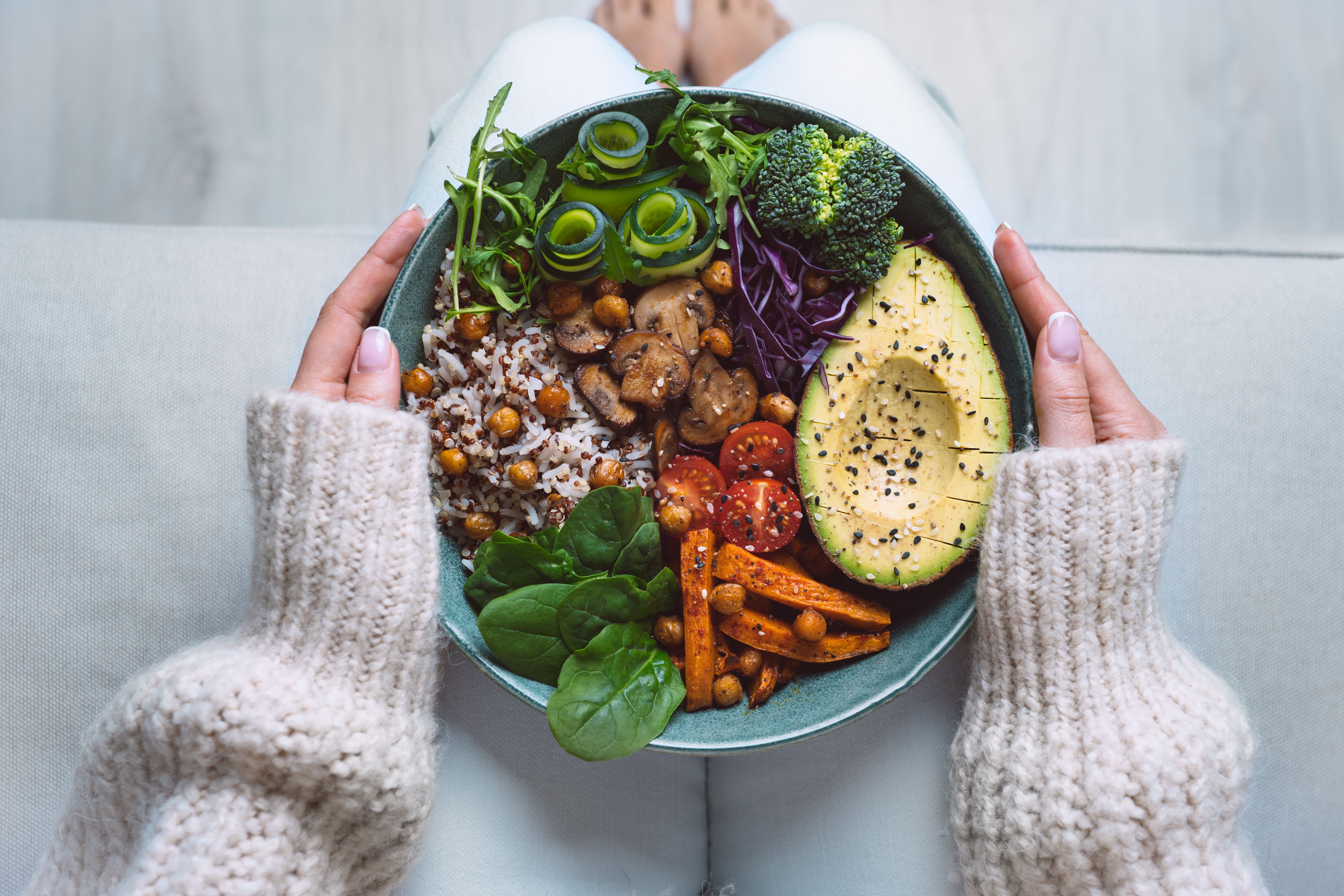 Healthy eating. Plate with vegan or vegetarian food in woman hands. Healthy plant based diet. Healthy dinner. Buddha bowl with fresh vegetables Healthy eating. Plate with vegan or vegetarian food in woman hands. Healthy plant based diet. Healthy dinner. Buddha bowl with fresh vegetables